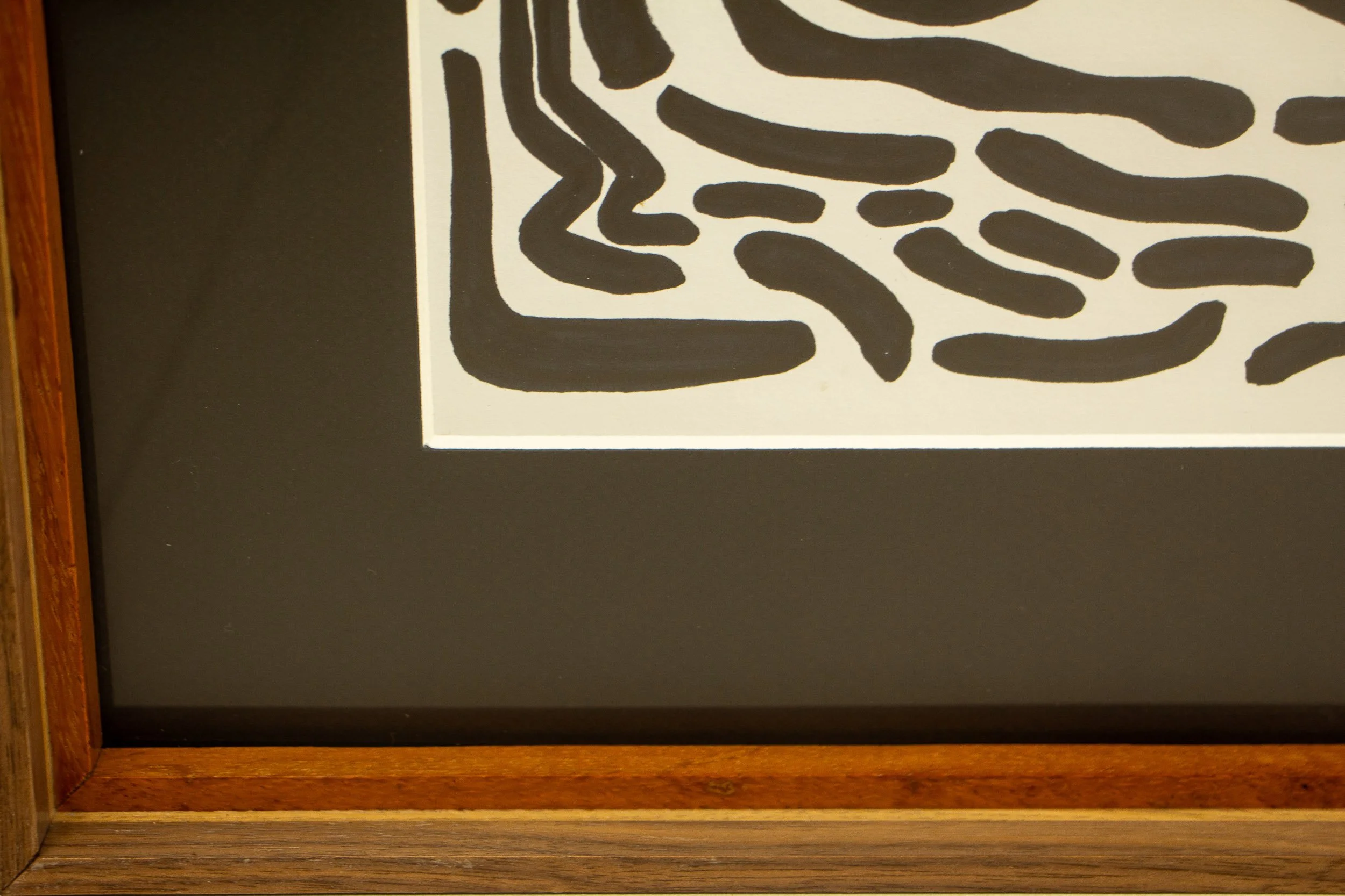 Mêlée of Discovery 004 frame: lower margin detail showing the black mount, the warm inner wooden lip, and the darker outer frame bands.