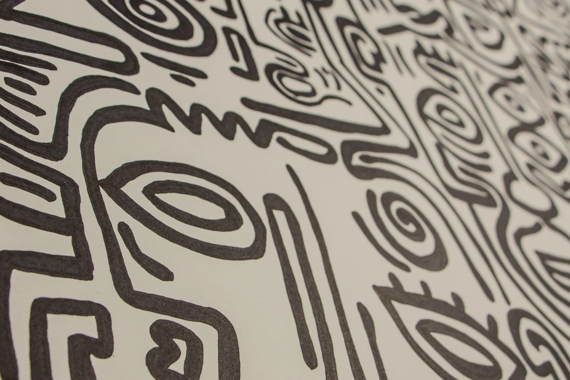 Resonant Syntax 002 detail: oblique close-up of an eye motif and spiral form, with bold black contours and open paper space creating rhythm across the surface