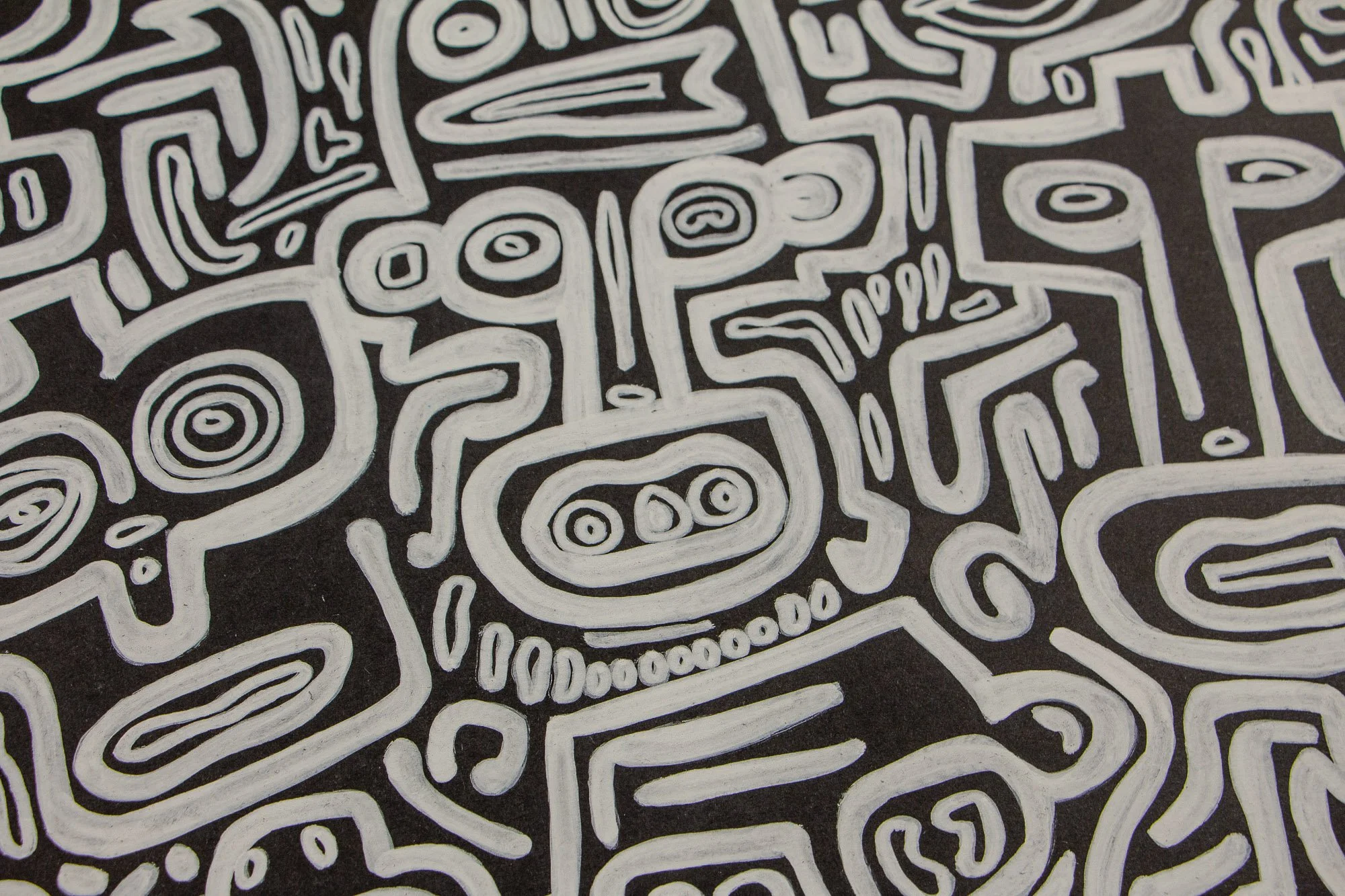 Turbulent Aegis 002 artwork detail: close-up of a central white-lined figure on a dark surface, with circular eyes, teeth-like marks, and surrounding forms that suggest tension contained within order.