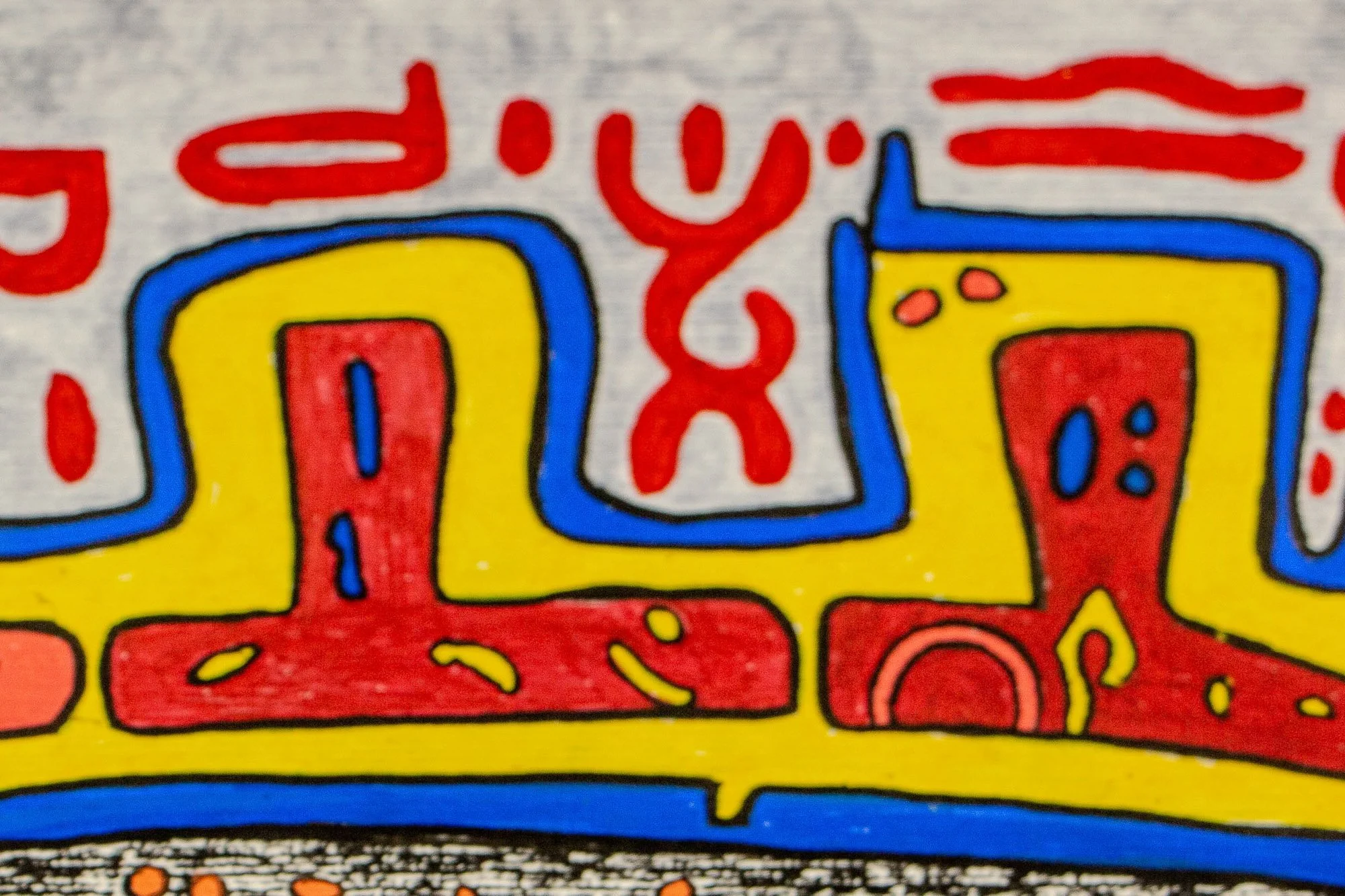 Unseen Signifiers 003 detail: close-up of the crown-like top form, showing red vertical shapes set into a yellow band outlined in blue against the pale background.