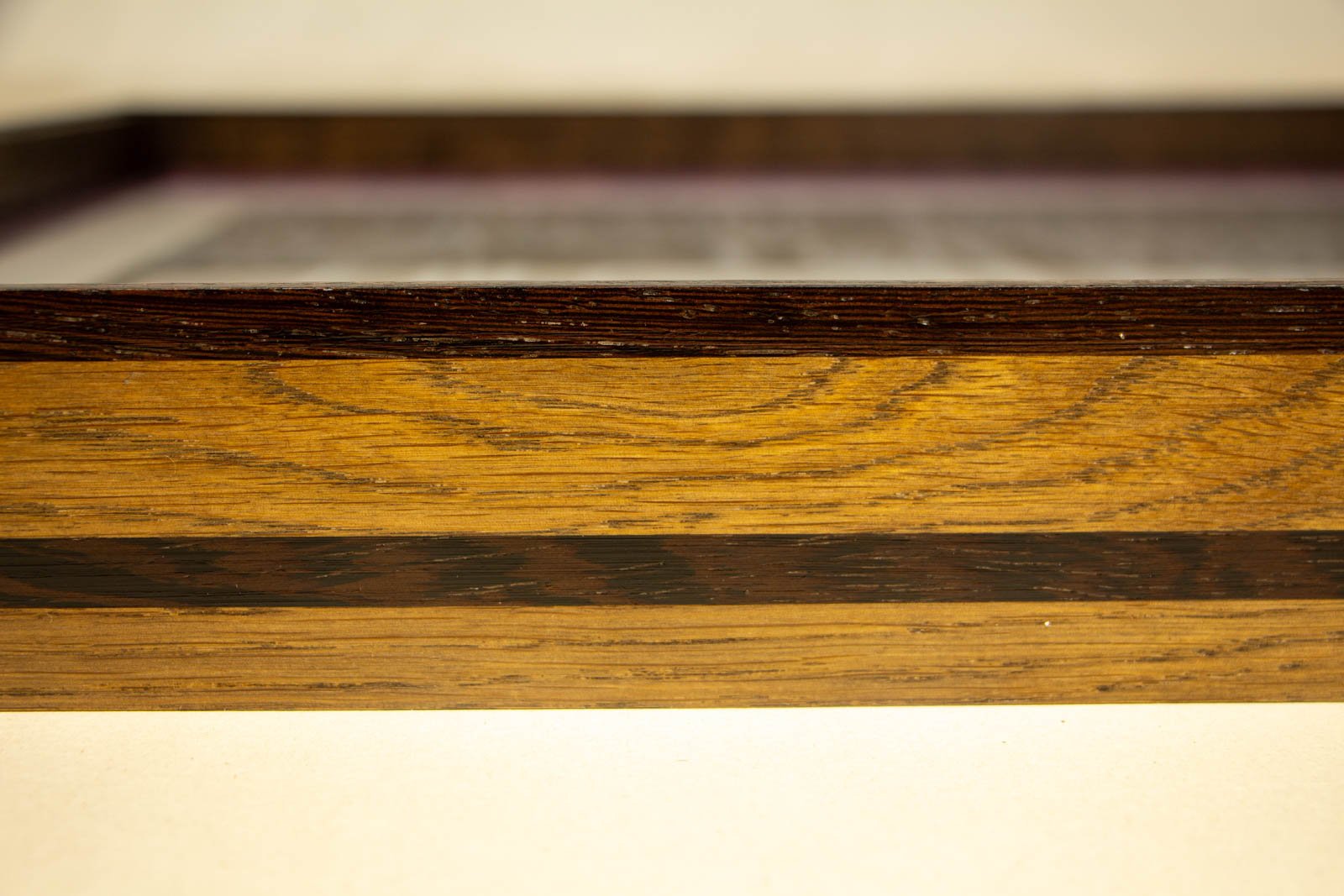 Synaptic Mythos 002 frame: straight side elevation, calm, even oak figure; dark wengé top edge reads clean; smooth satin sheen