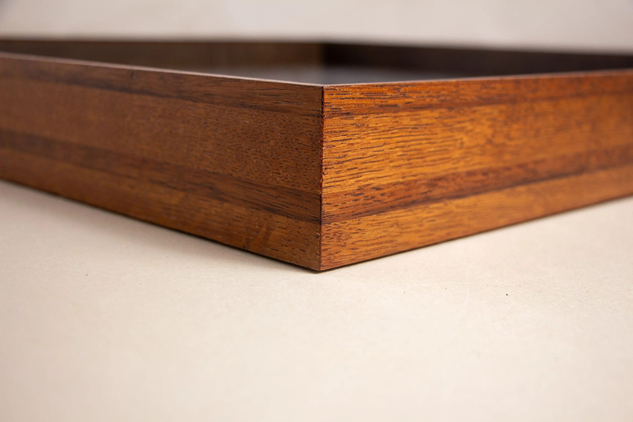 Turbulent Aegis 003 frame detail: close-up of a frame corner with sharp mitering, emphasizing the refined craftsmanship, tonal transitions in the wood, and the polished finish across the layered bands.