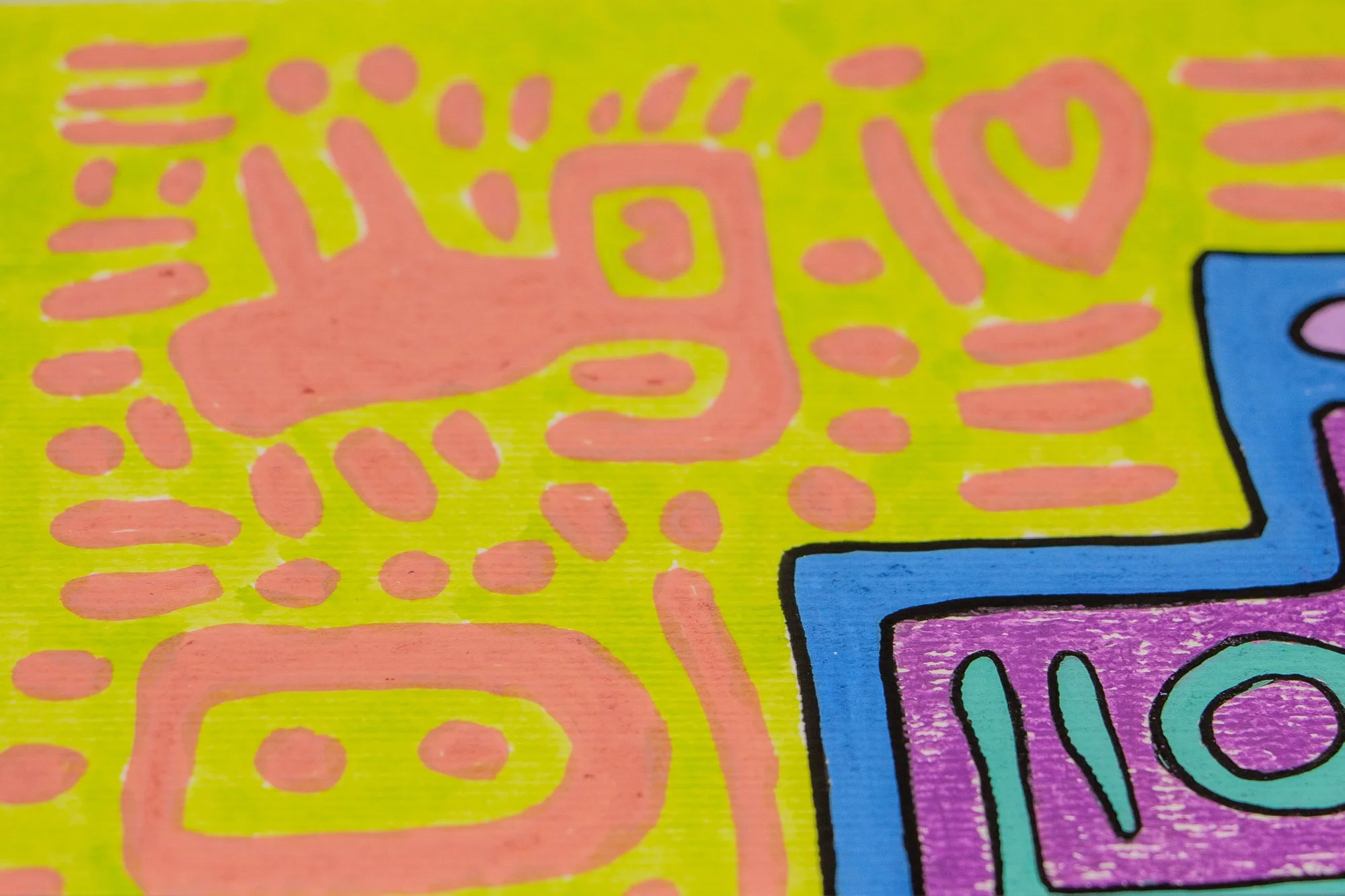 Unseen Signifiers 009 artwork detail: close-up of the lime-yellow background with pink symbols, including a rounded figure and a heart motif beside the blue outer contour.