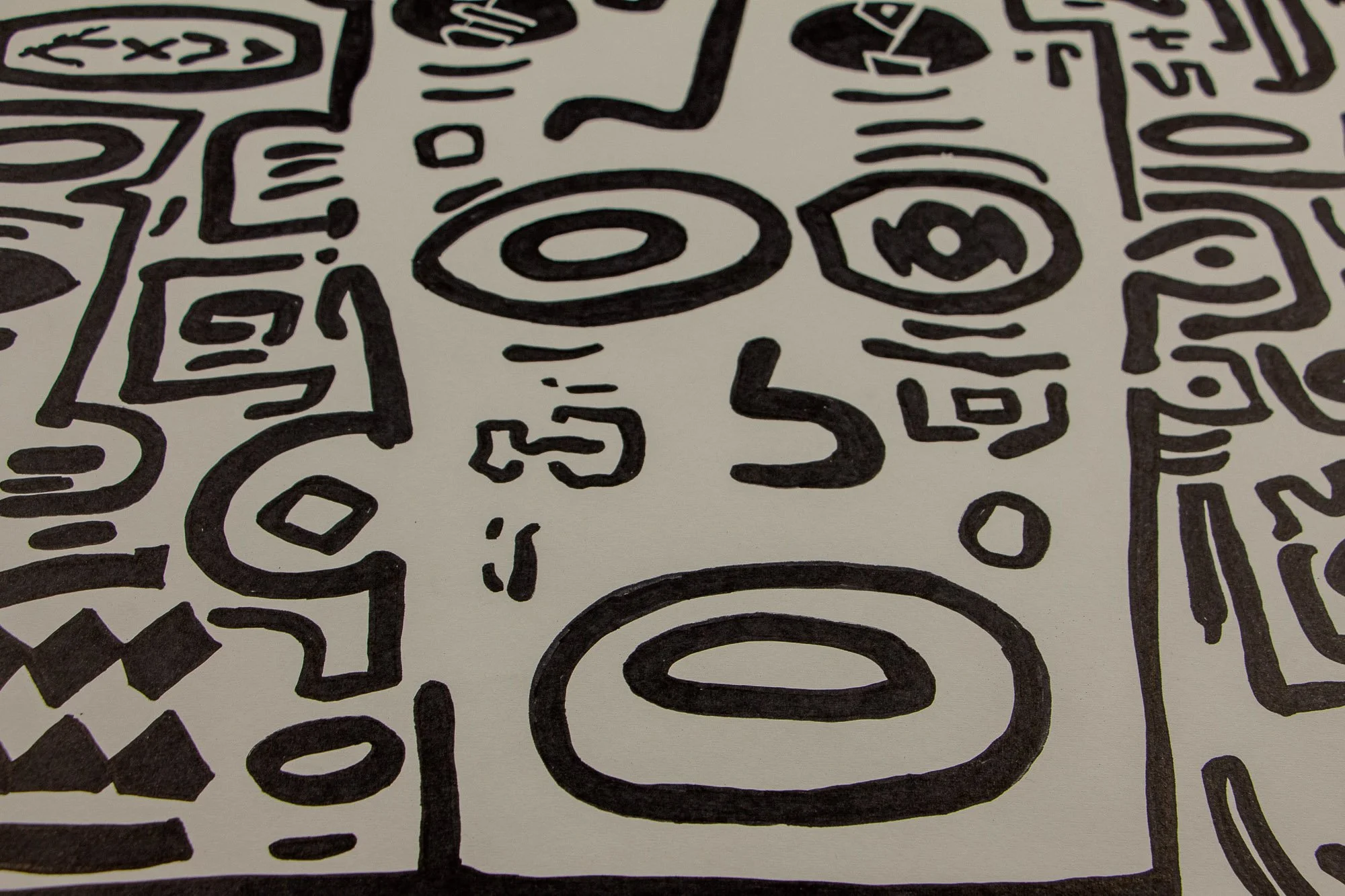 Elusive Cocoon 001 detail: angled section with an almond eye, oval forms, and a geometric face with diamond-shaped teeth, set within dense black contour lines and adjacent abstract symbols.