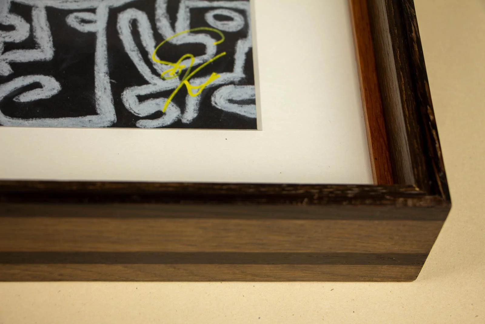 Synaptic Mythos 001 frame: lower-right interior, signature margin, off-white mount, and the inner color slip meeting at a clean inside mitre