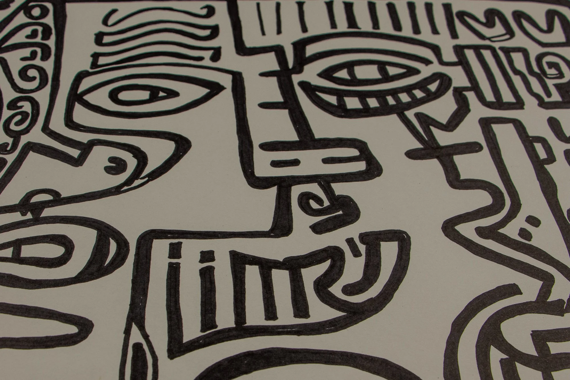 Elusive Cocoon 004 detail: close-up of a central angular face with a grinning mouth, heavy-lidded eye, and adjacent profile-like form built from sharp black contours and compact symbols.