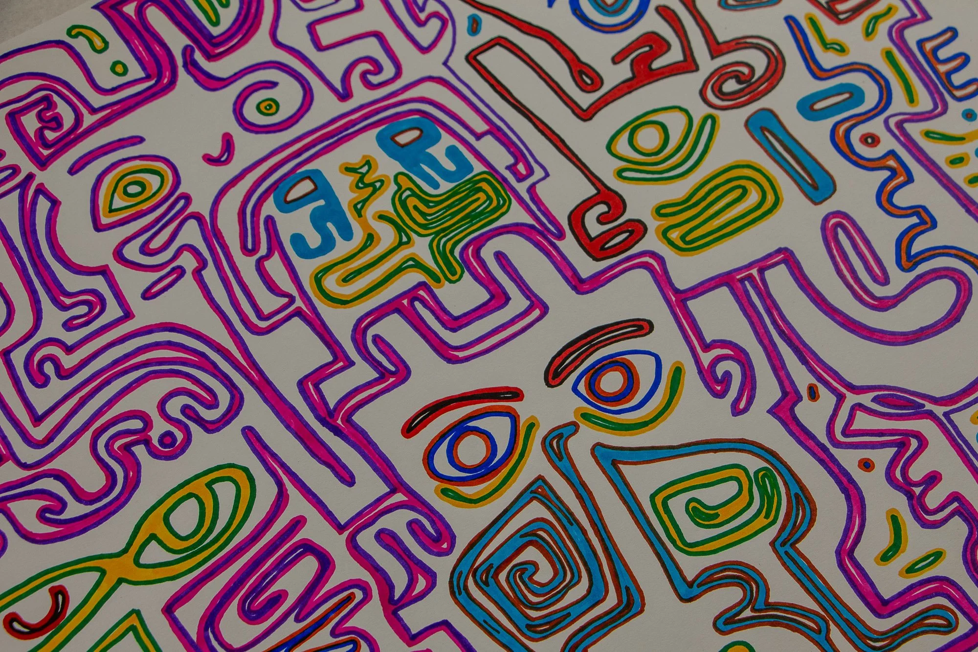 Eclipsing Gravitas 003 detail: angled view of interconnected face-like and abstract forms outlined in pink, violet, red, green, and blue, with stacked features, spirals, and linear motifs spreading diagonally across the sheet.