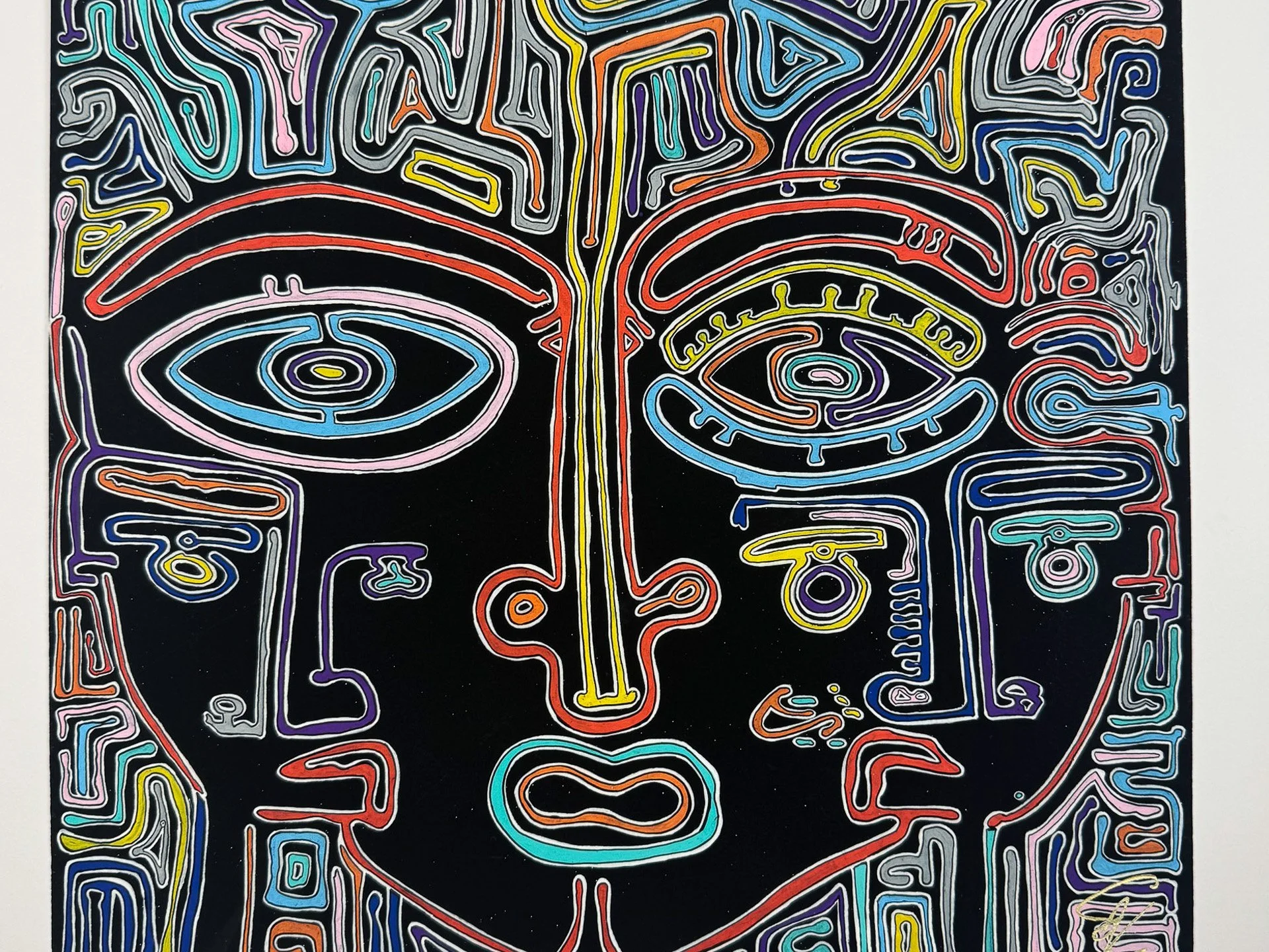 Full unframed artwork showing a large stylized face outlined in pink, red, yellow, blue, orange, violet, green, and grey lines on black, surrounded by dense labyrinth-like symbols and finished with a gold signature in the lower right corner.