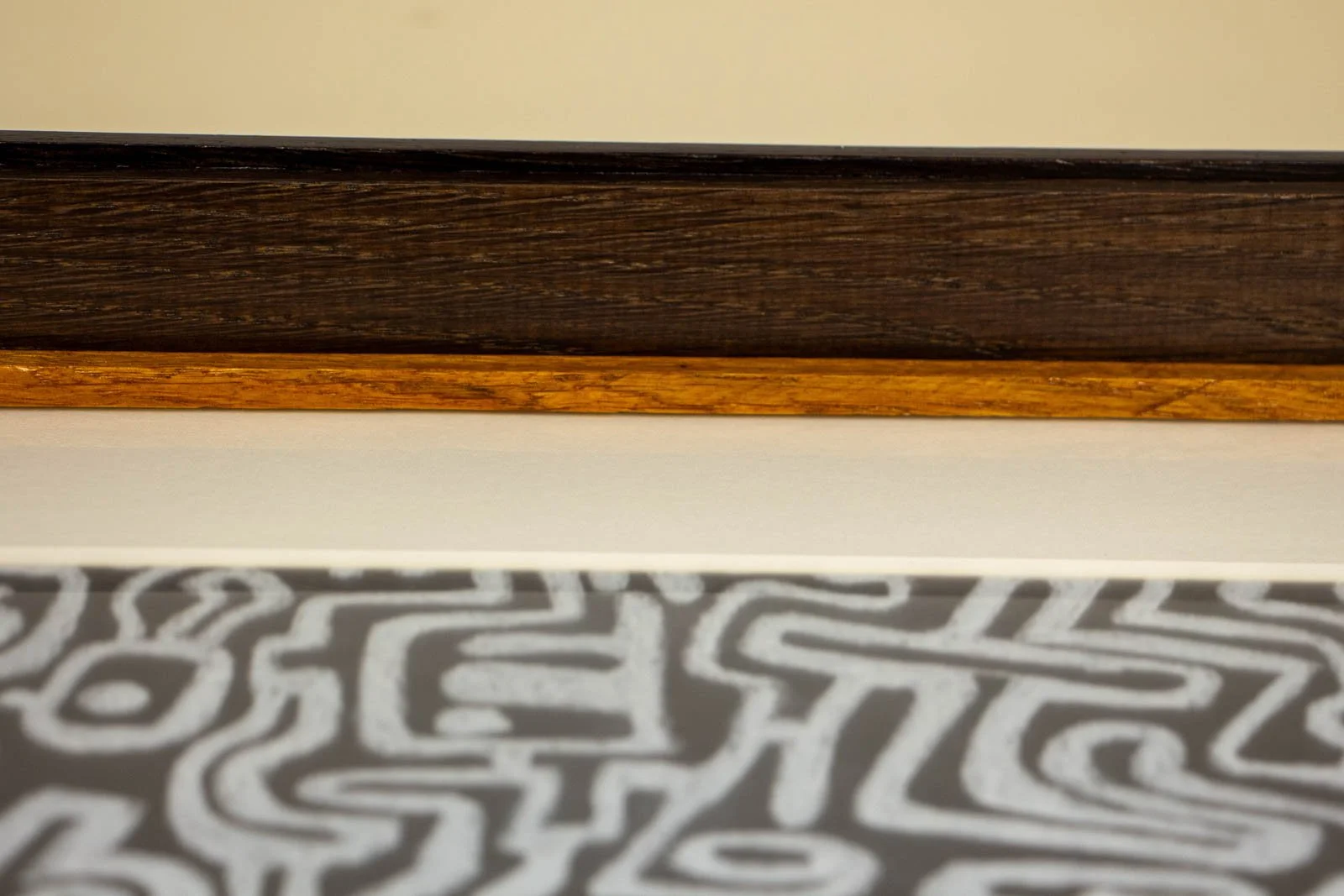 Synaptic Mythos 001 frame: inner throat with off-white mount; slim color accent slip for Denial (purple in the series concept) below the wengé cap; shallow shadow gap