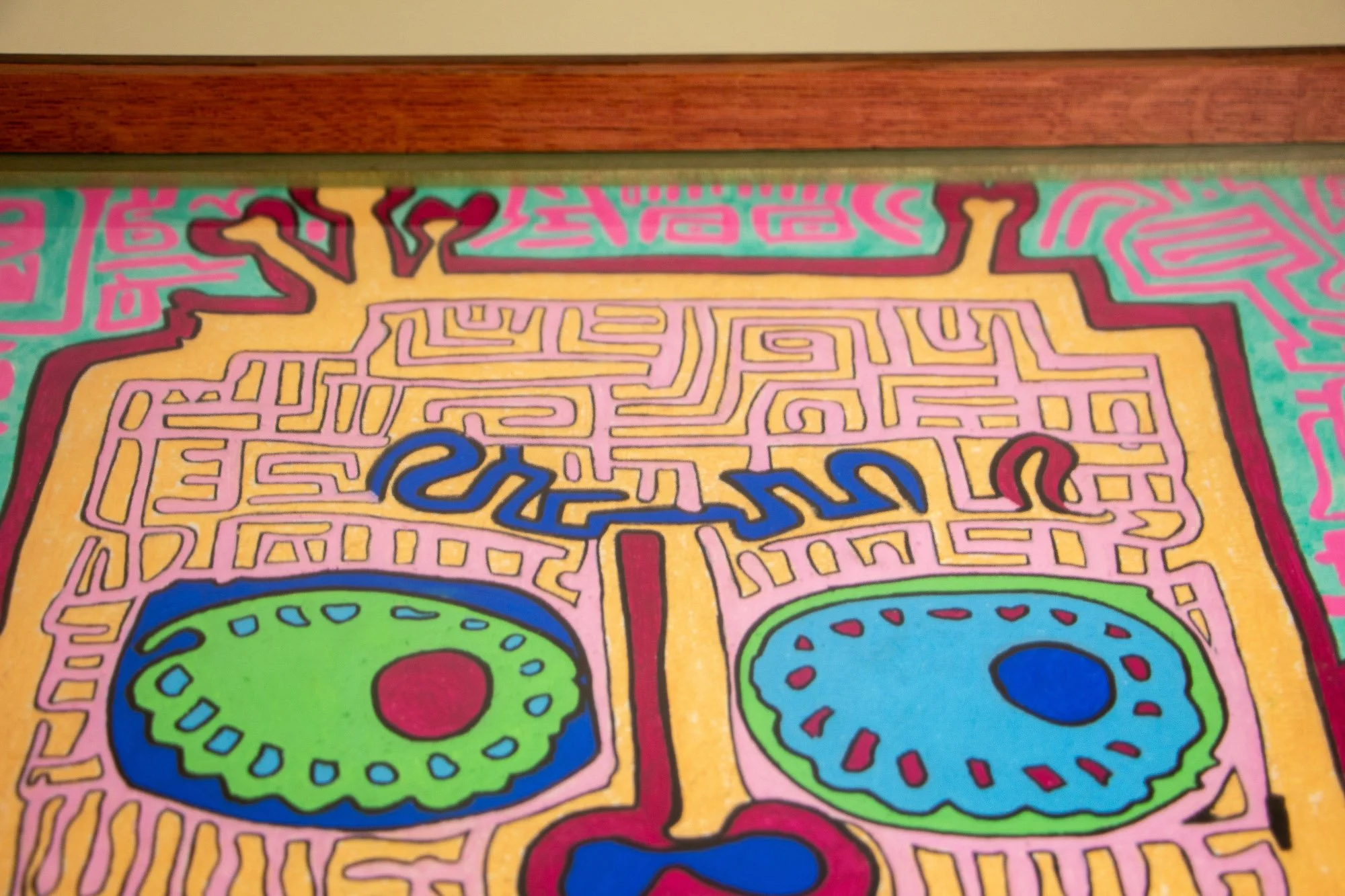 Unseen Signifiers 004 frame detail: upper composition view with the frame’s reddish top rail spanning above the face-like form, revealing the relationship between the artwork and its deep-set glazing. mahogany, oak and beech wood.