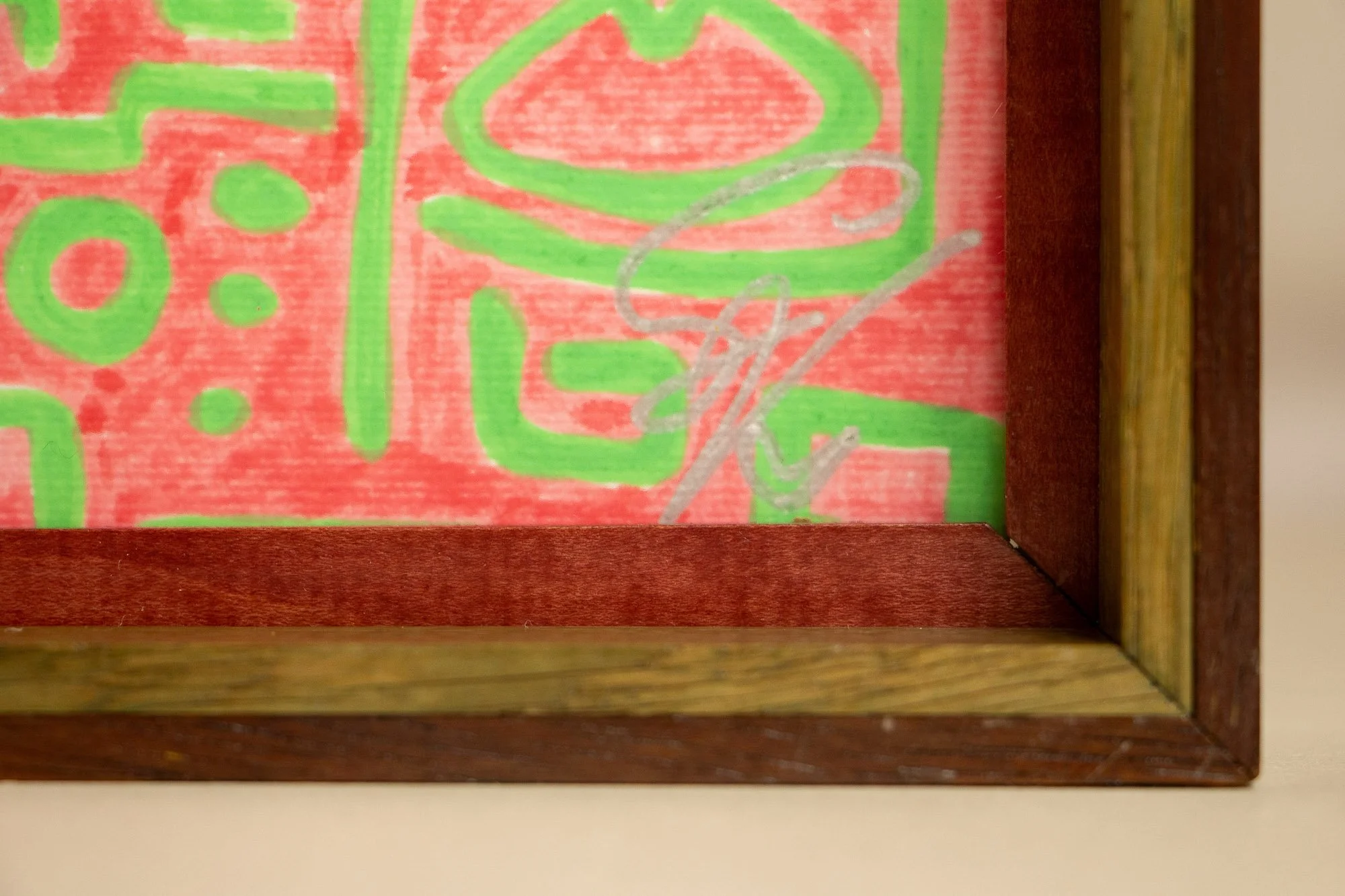 Unseen Signifiers 001 frame detail: lower right corner detail of the frame and artwork, showing the layered wood construction and the silver signature placed just inside the inner edge. mahogany, oak and beech wood. mahogany, oak and beech wood.