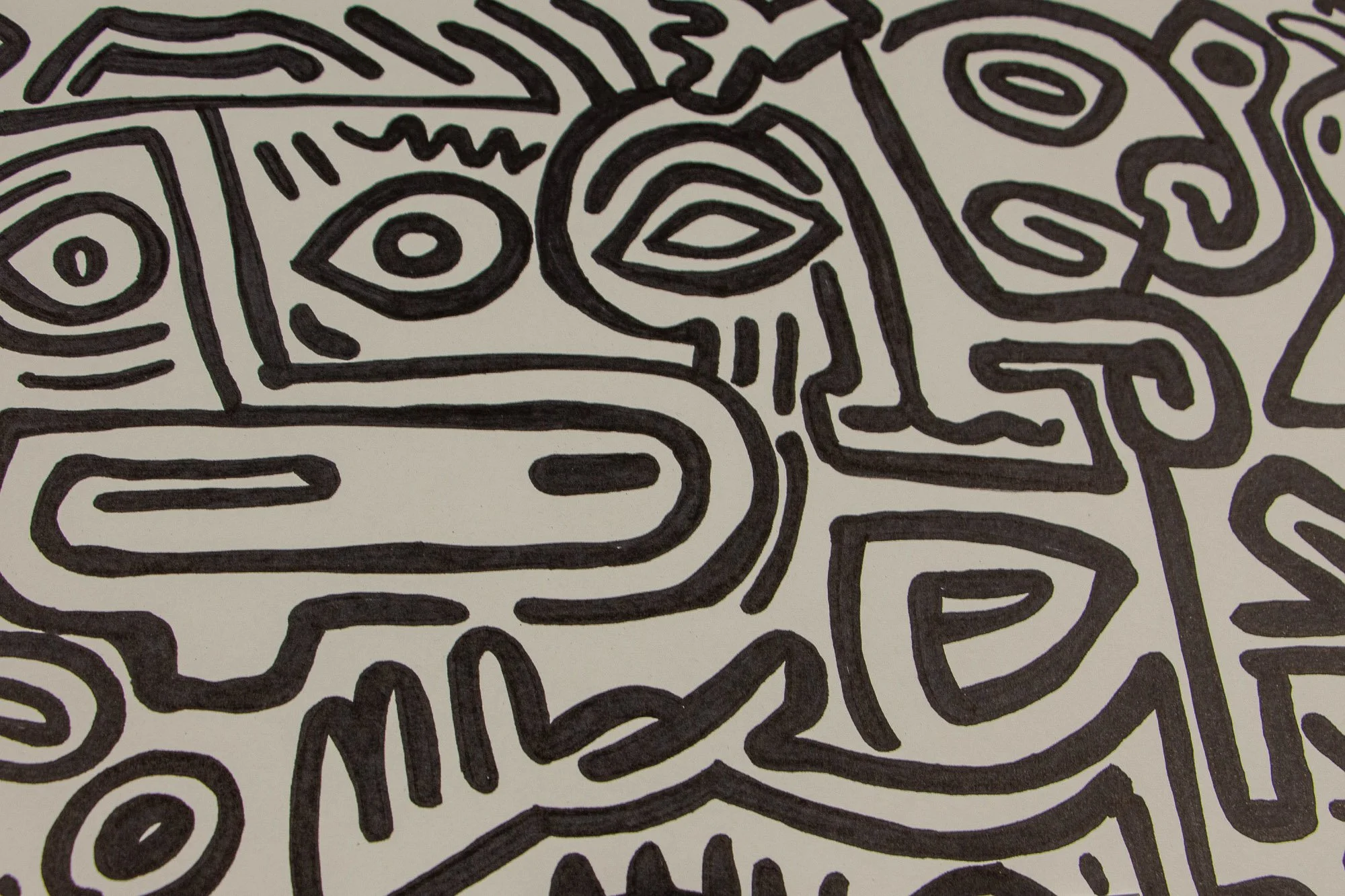 Resonant Syntax 002 detail: frontal close-up of the upper central mask, with one circular eye, one almond-shaped eye, and a long rounded horizontal mouth in dense black linework