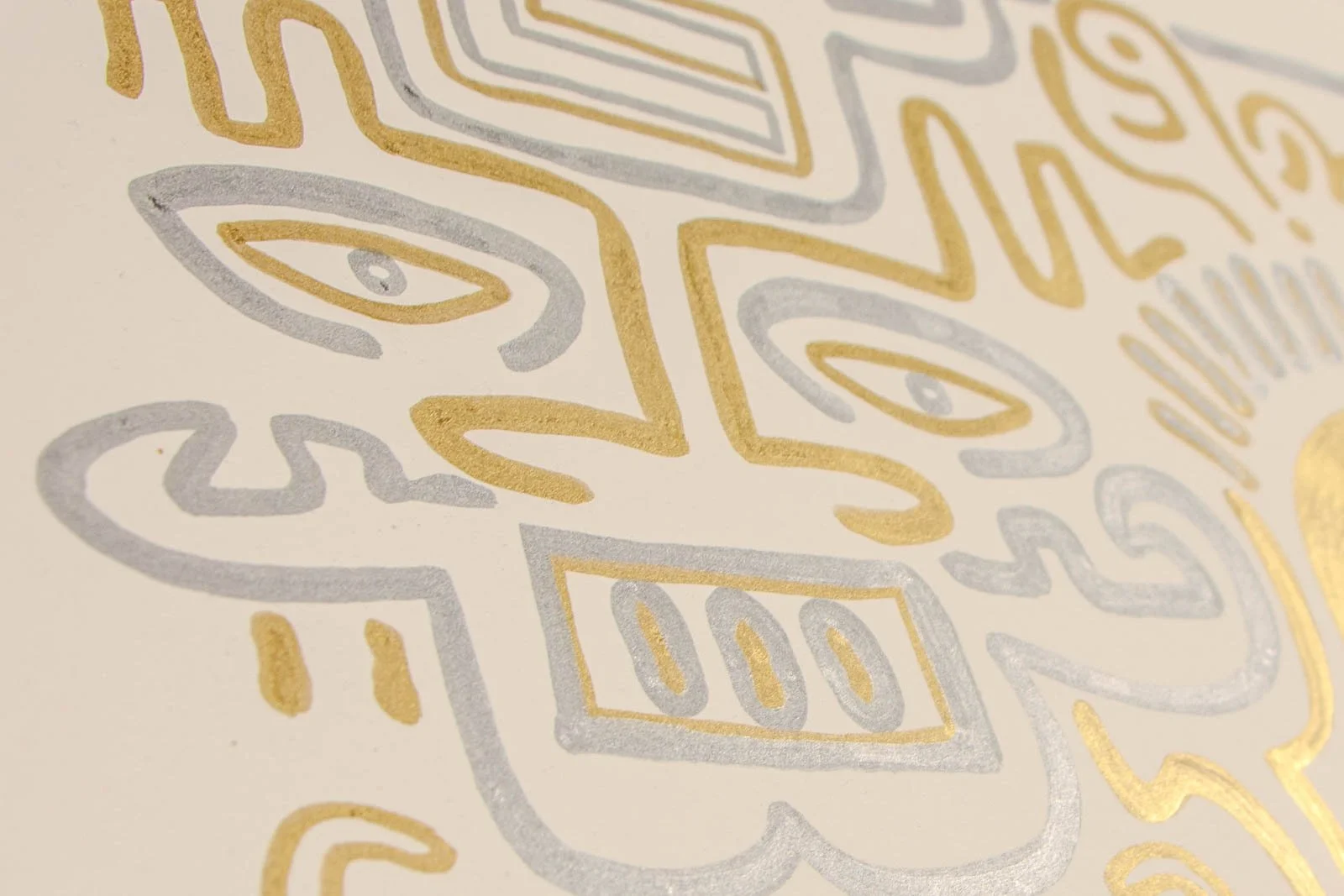 Golden Nostalgia 003 detail: mask cluster, angled view of twin eyes and stepped rectangles; raised metallic strokes catch the light