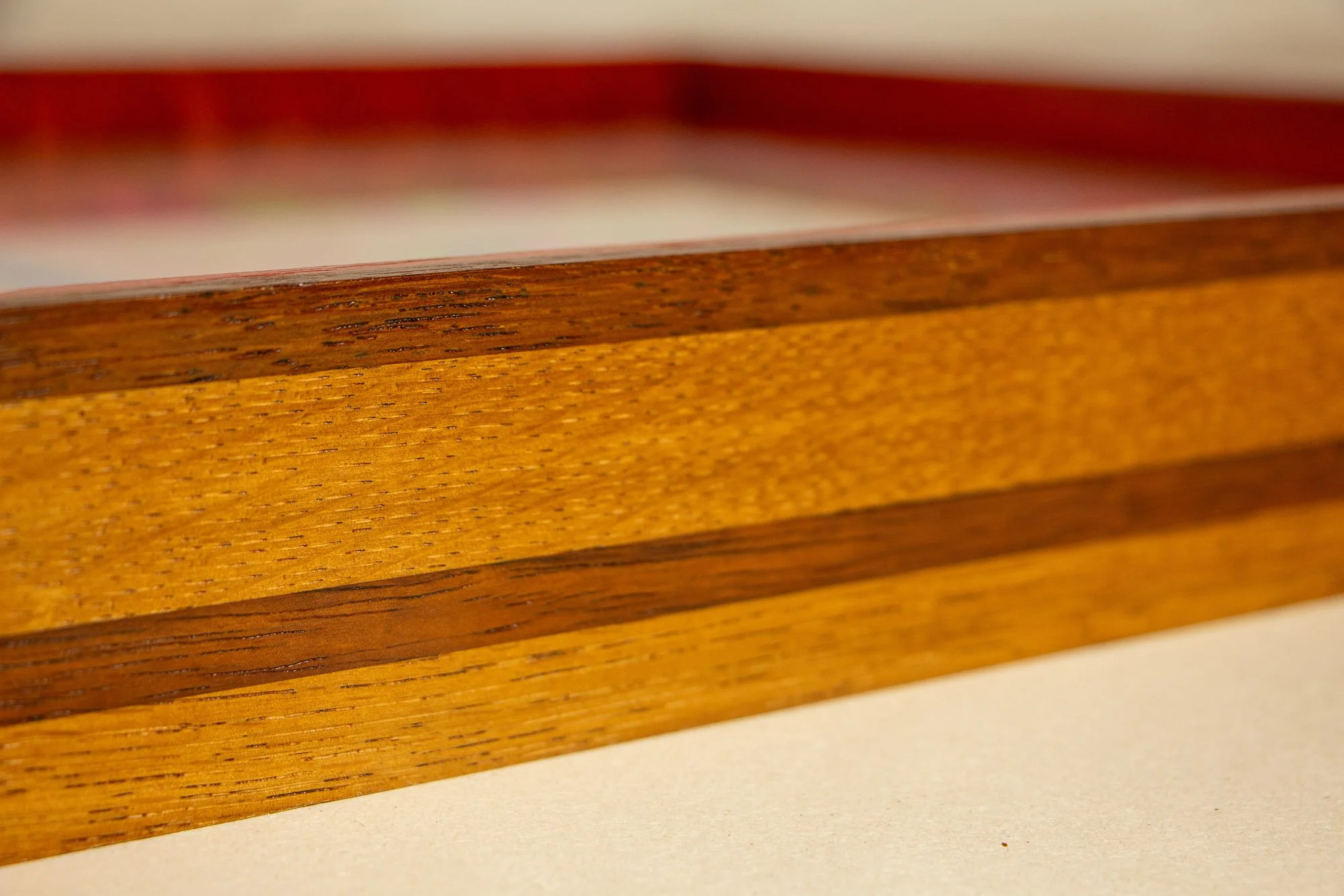 Unseen Signifiers 008 frame detail: oblique side view of the frame profile, emphasizing the polished wood grain, layered strip construction, and the depth of the box frame. mahogany, oak and beech wood.