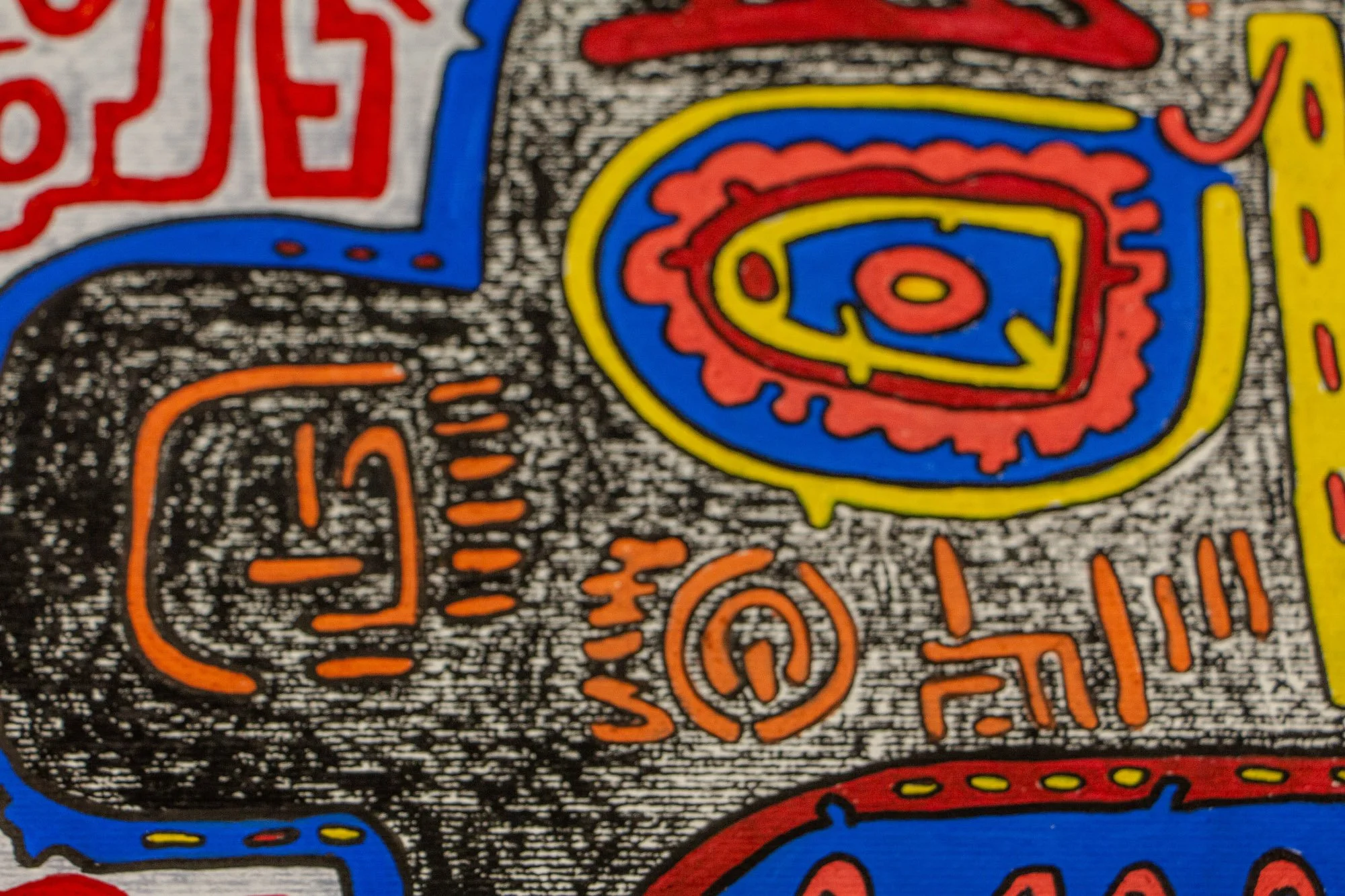 Unseen Signifiers 003 detail: close-up of the left side of the face, where orange symbols and vertical marks sit against the dense black-and-white ground beneath the layered eye form.