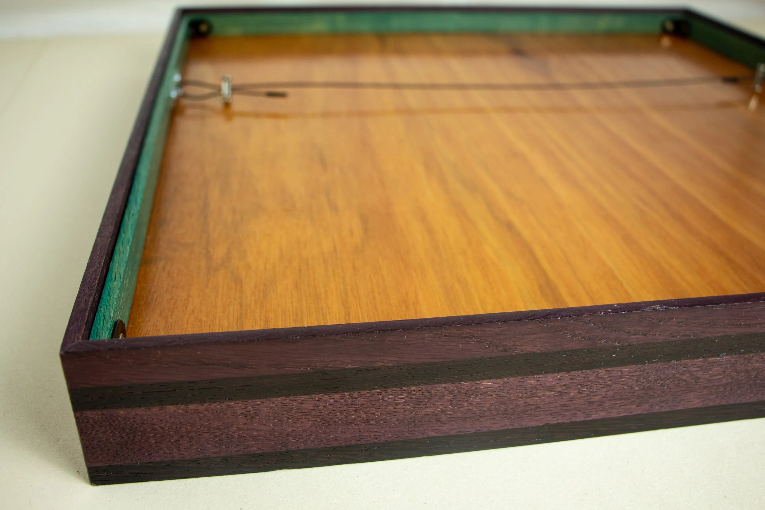 Formless Equation 001 frame: full back panel view with perimeter green spacer and purpleheart outer rail