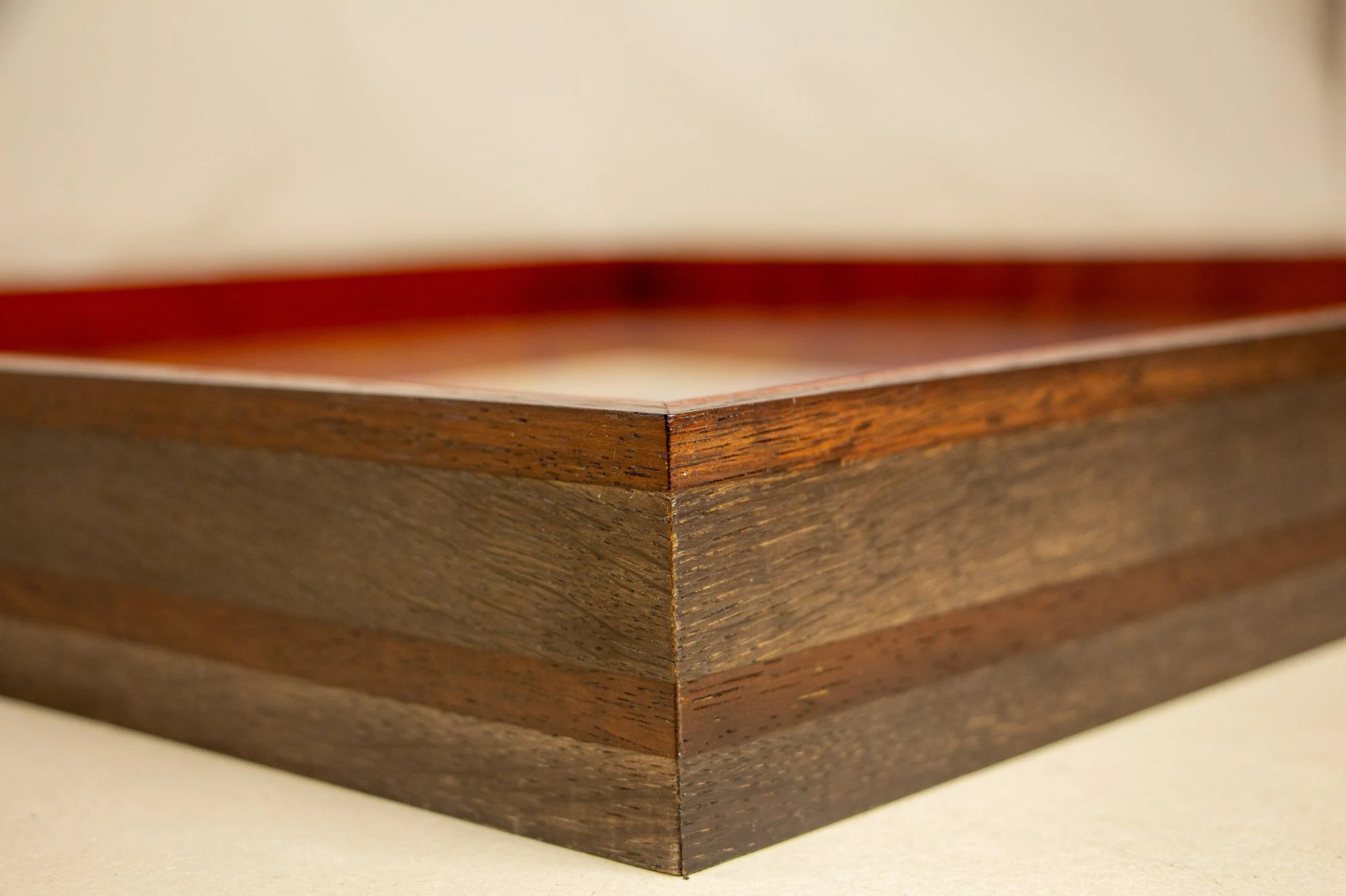 Unseen Signifiers 003 frame detail: corner close-up of the frame, showing the glass edge, sharp miter join, and the layered dark-brown wood profile with subtle tonal variation. mahogany, oak and beech wood.