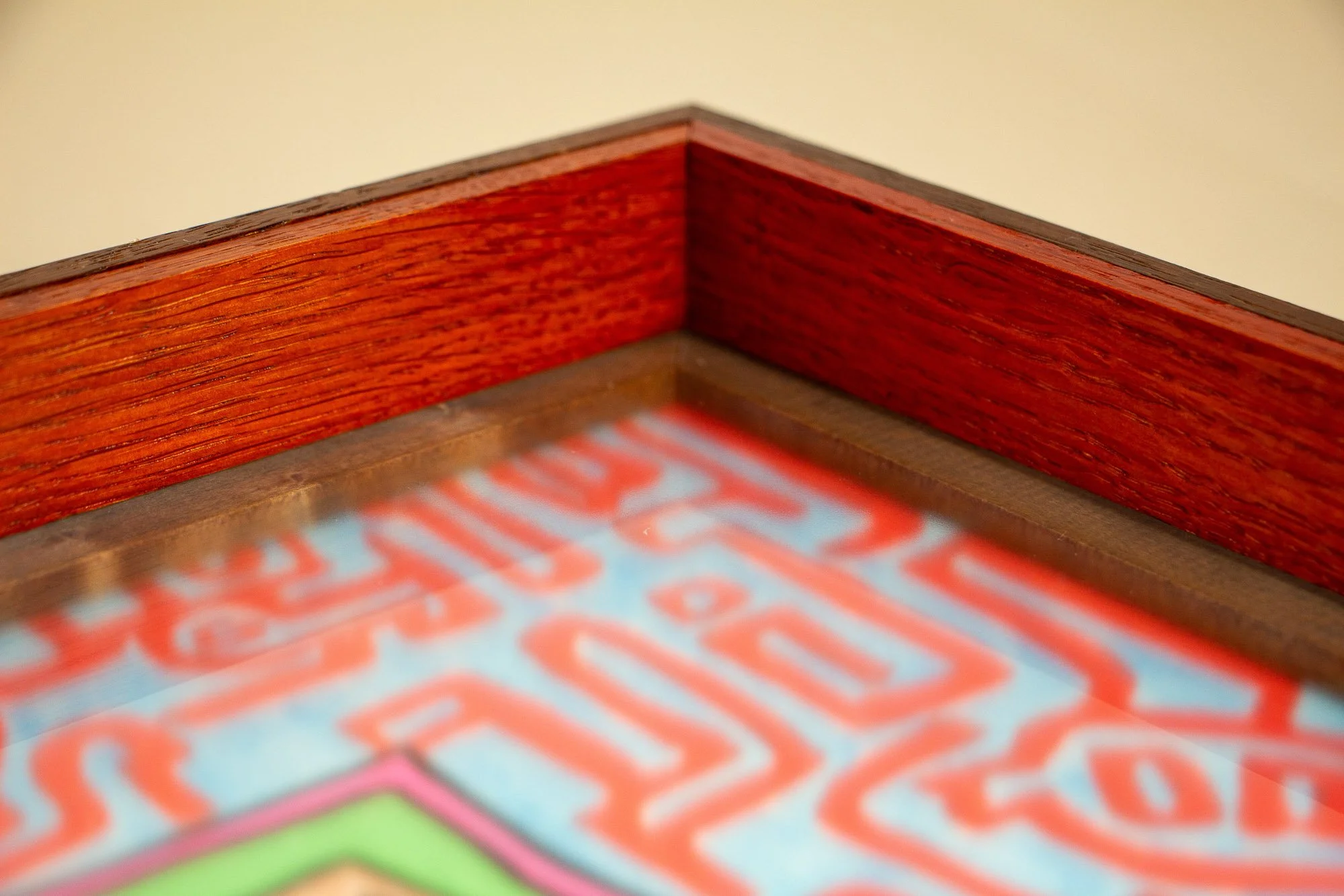 Unseen Signifiers 008 frame detail: close-up of the inner corner, highlighting the vivid red lacquered inner frame and the dark inner border around the glazed artwork. mahogany, oak and beech wood.