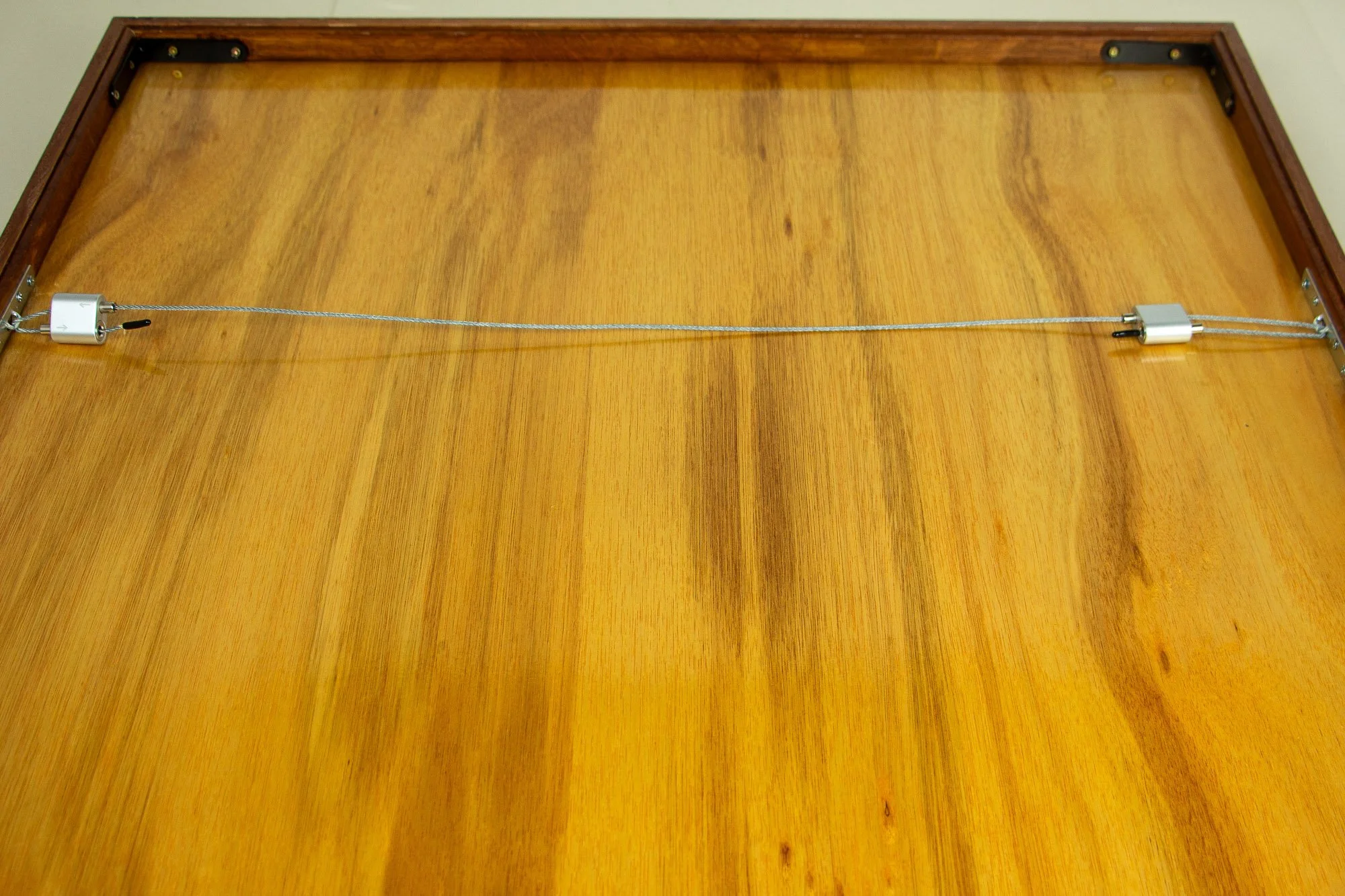 Elusive Cocoon 001 frame back: close-up of the adjustable steel hanging wire hardware fixed securely to the rear rail.