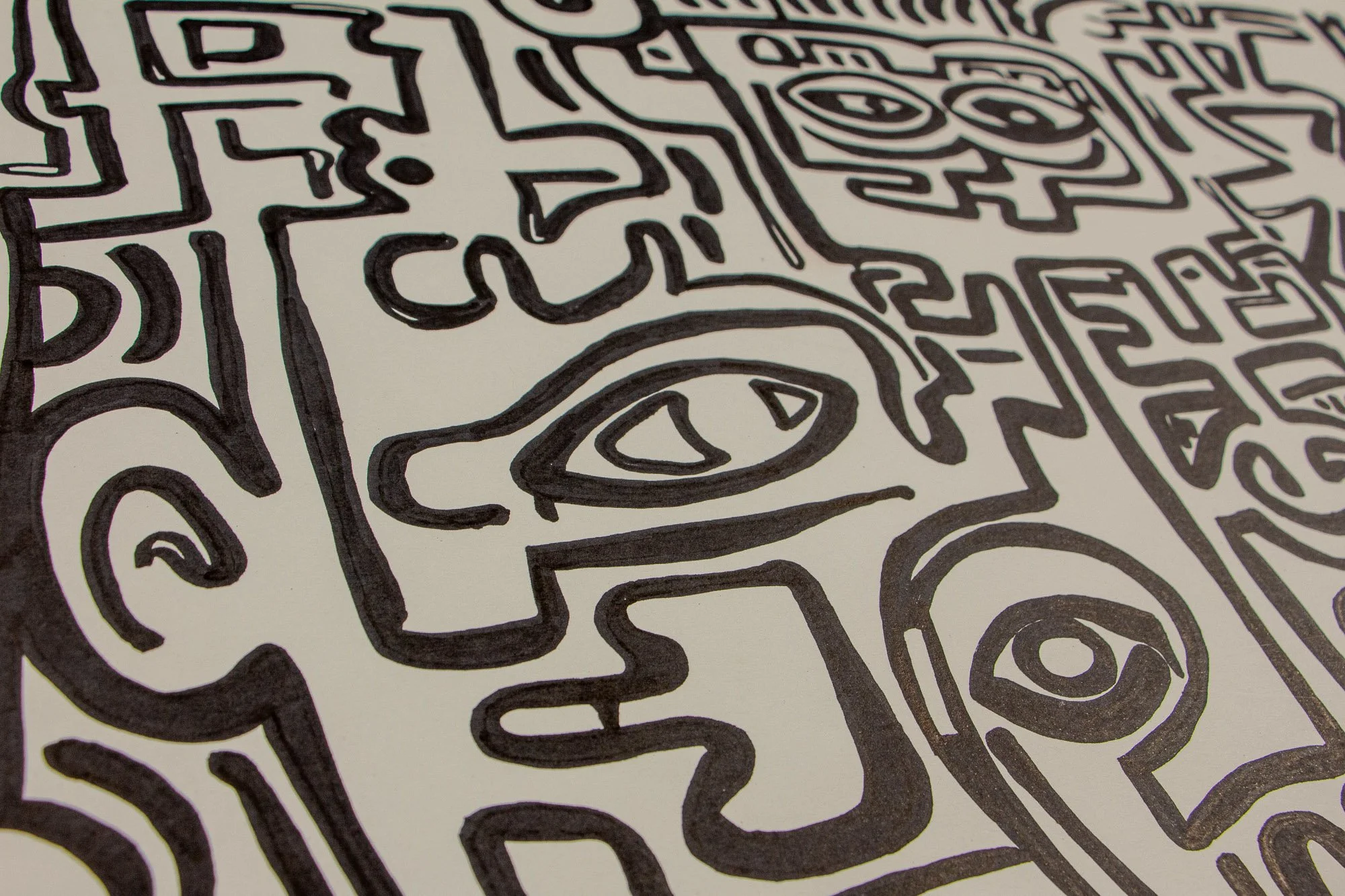 Elusive Cocoon 003 detail: angled close-up of the left side, focusing on a profile-like face with an almond eye, a large circular eye below, and adjacent dense black linear signs across the pale surface.