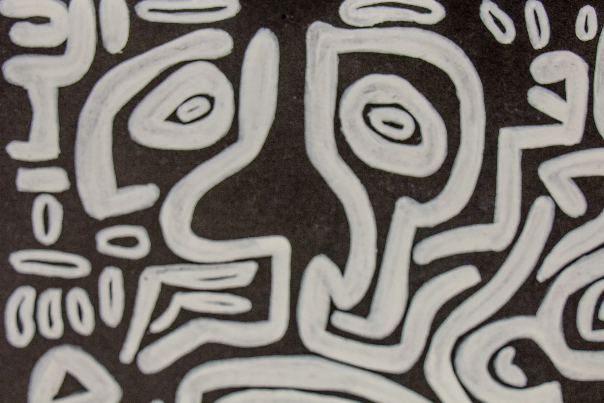 Turbulent Aegis 002 artwork detail: close-up of two adjacent head-like figures rendered in white lines on a dark surface, their mirrored forms creating a sense of dialogue and tension.