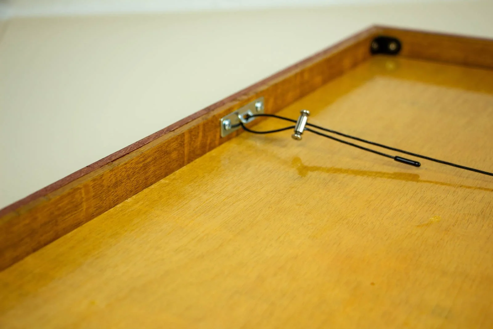 Metamorphic Entwining 001 frame: reverse view with slotted hanger plate and adjustable wire clamp on the back panel