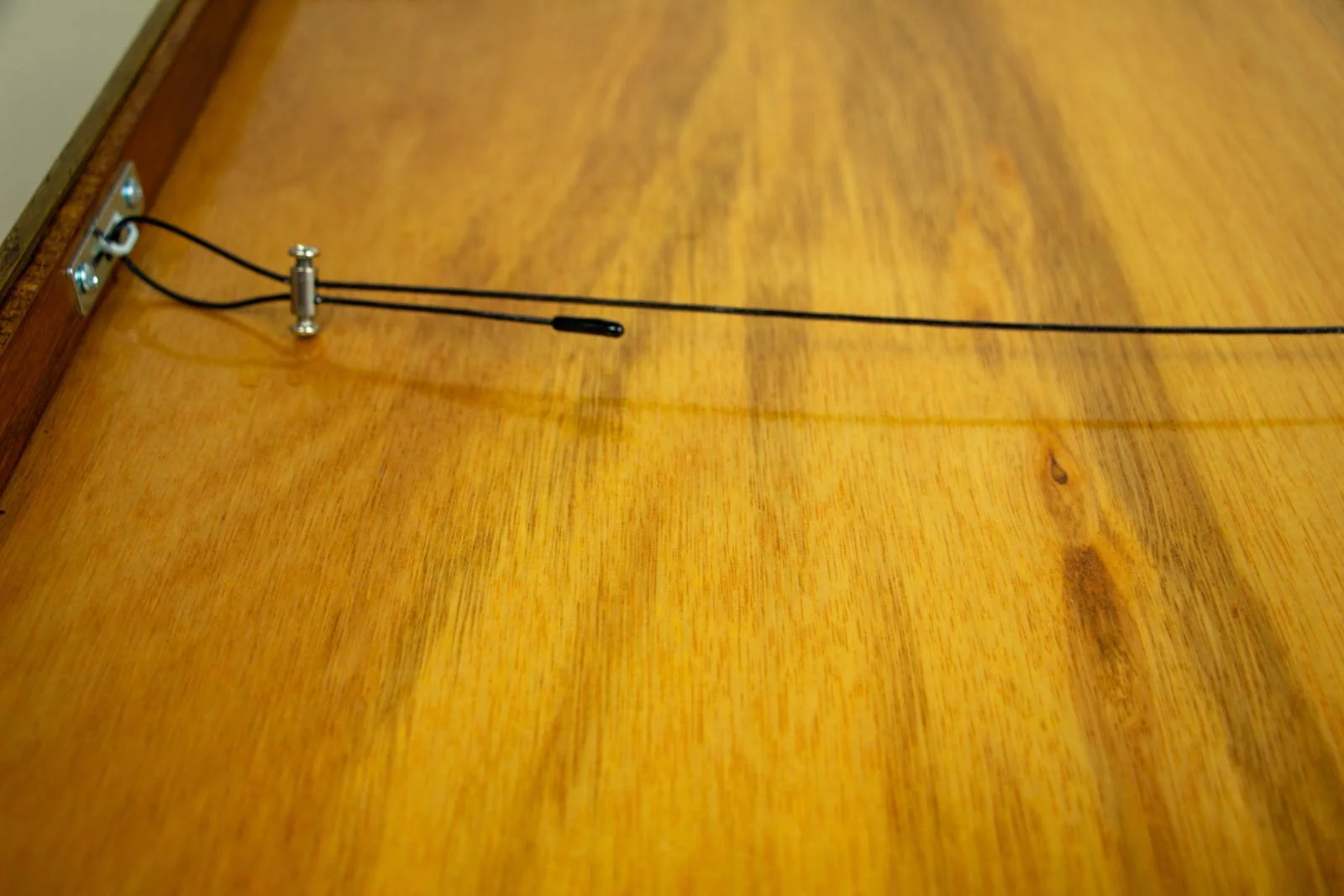 Metamorphic Entwining 004 frame: back view with black hanging wire, nickel plate and loop connector; neatly tensioned