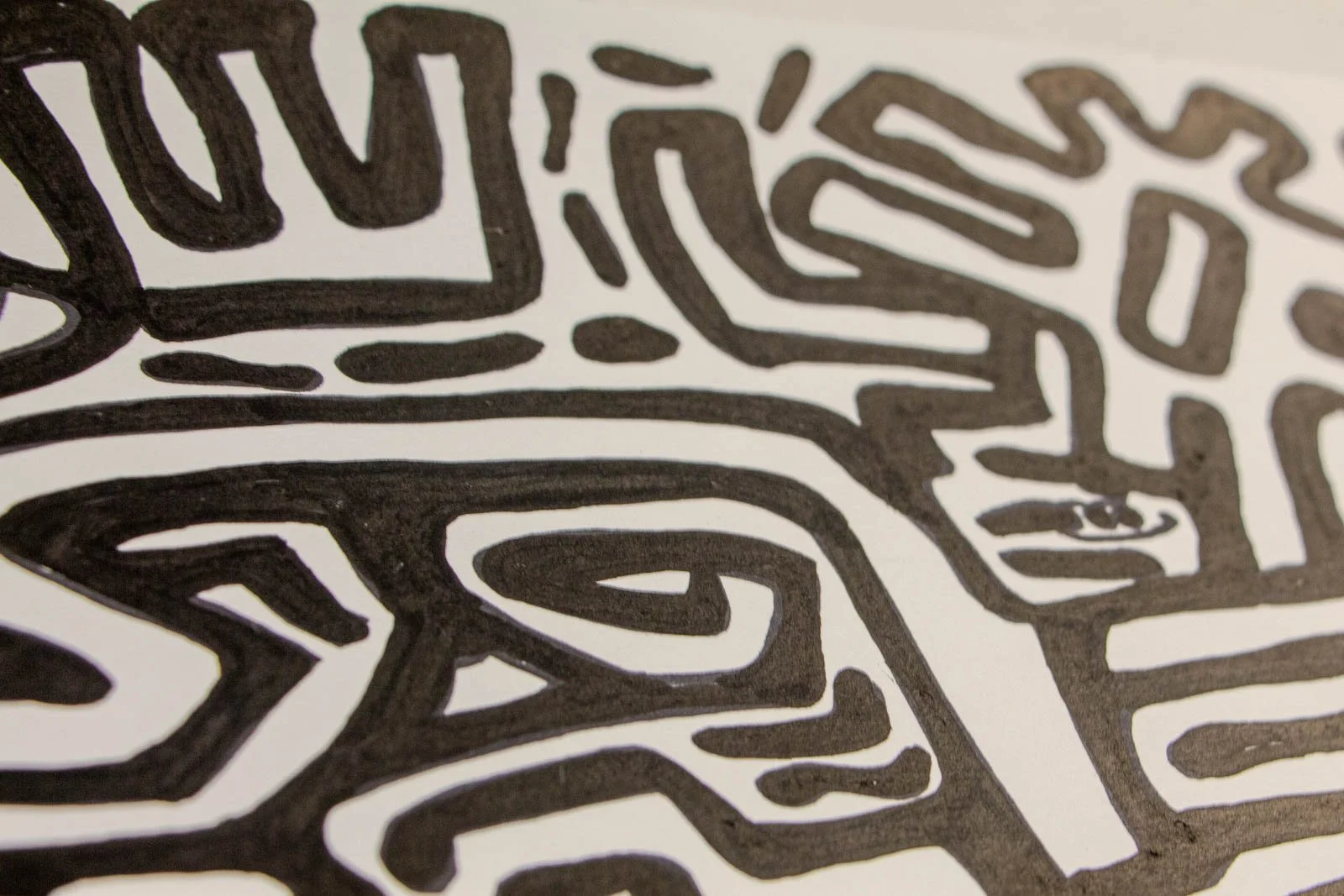 Formless Equation 003 detail: right face with curved lips and spiral eye accents, low perspective, ink on paper