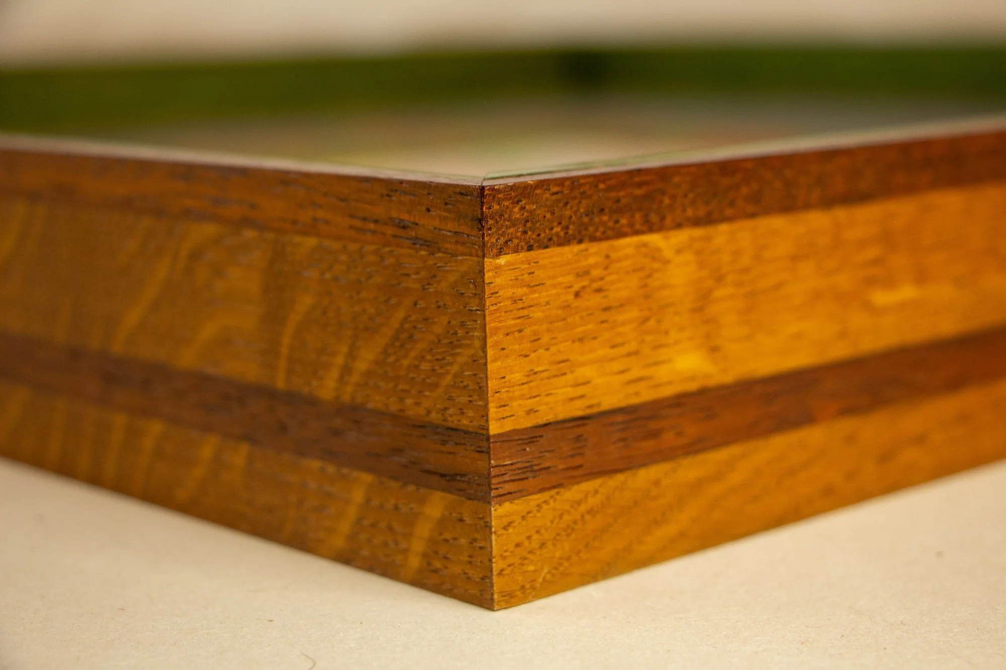 Unseen Signifiers 002 frame detail: angled corner view of the frame, highlighting the clean miter join, the glass surface, and the tonal shifts across the wood grain. mahogany, oak and beech wood.