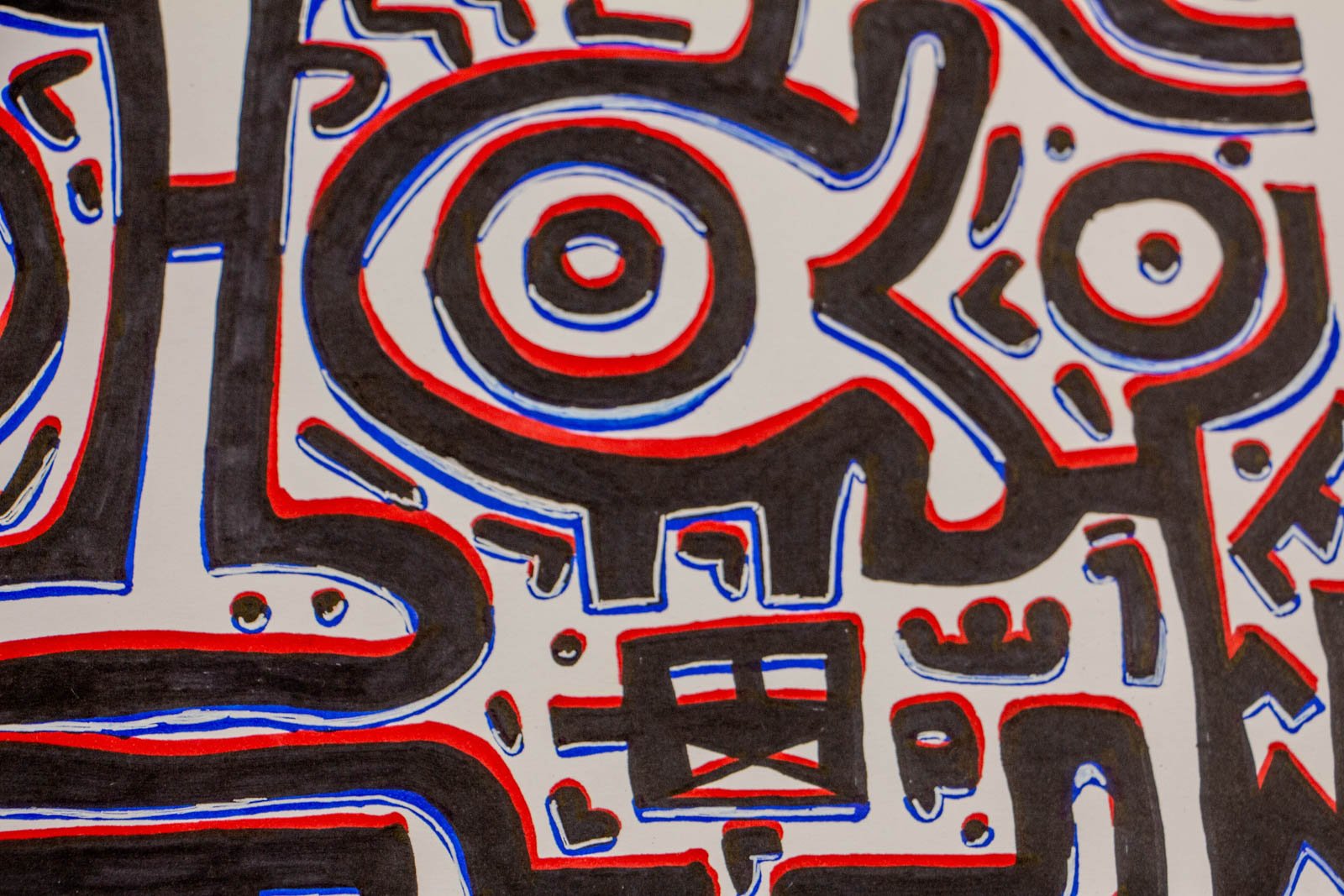 Flux Impromptu 002 detail: fish-eye emblem, concentric rings inside a tapered outline; boxed X below with scattered dots