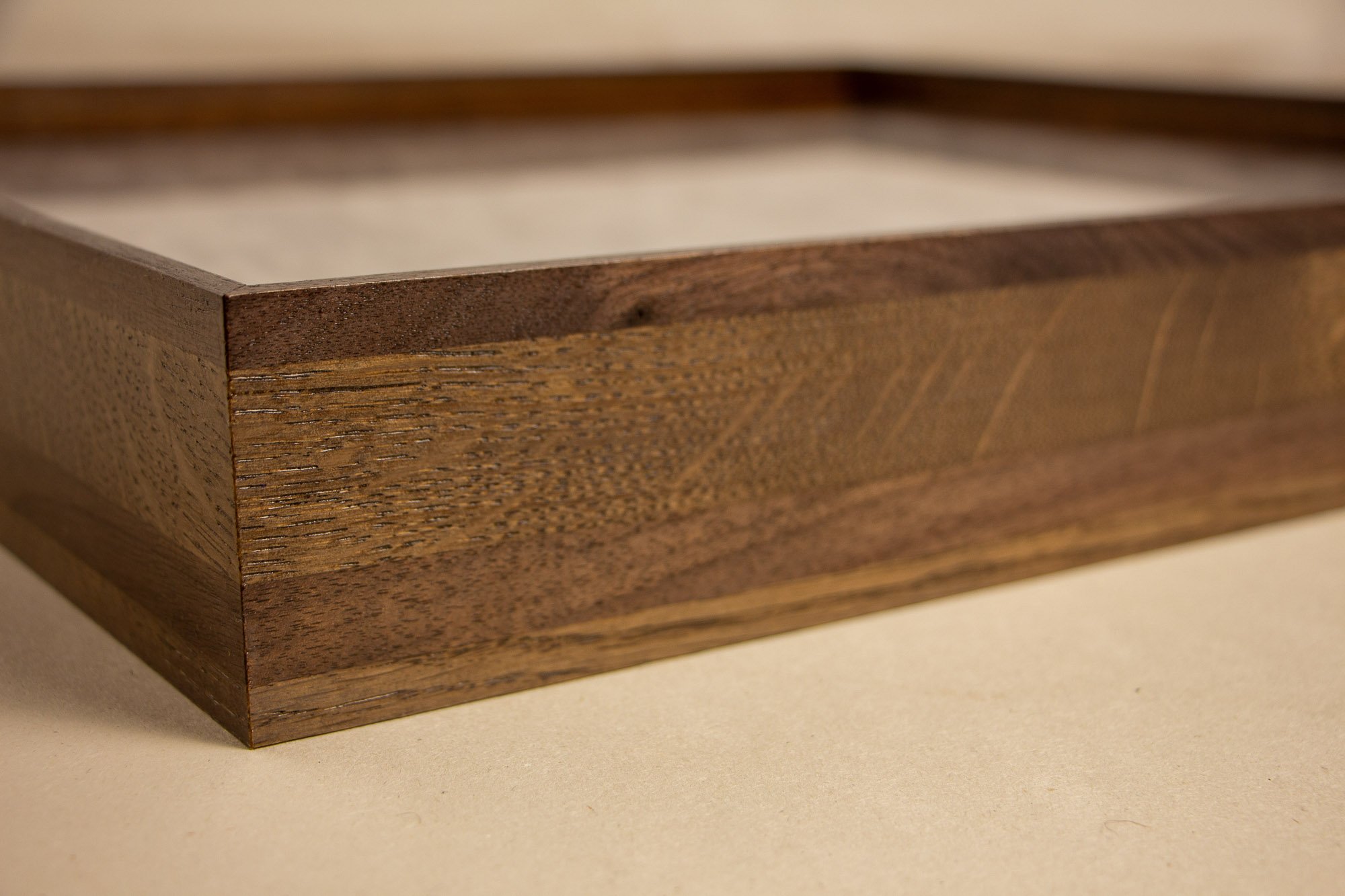 Luminous Parallax 003 frame: angled side view of the frame profile, showing the layered construction and tonal contrast between the darker outer edge and lighter central wood band.