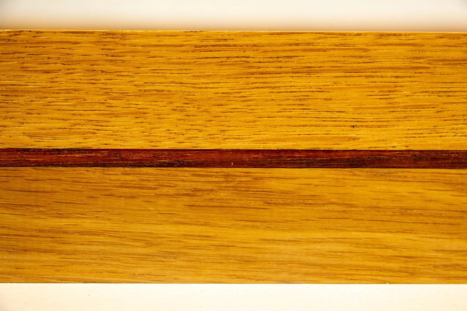 Golden Nostalgia 001 frame: close crop, mahogany inlay centered within the oak field; warm honey tone