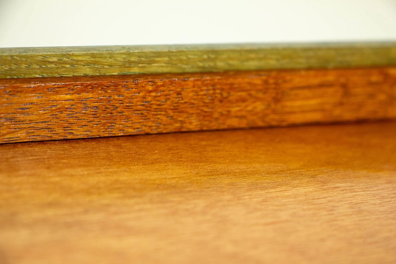 Formless Equation 002 frame detail (back): olive inner rail with cherry-toned support, smooth varnished back panel