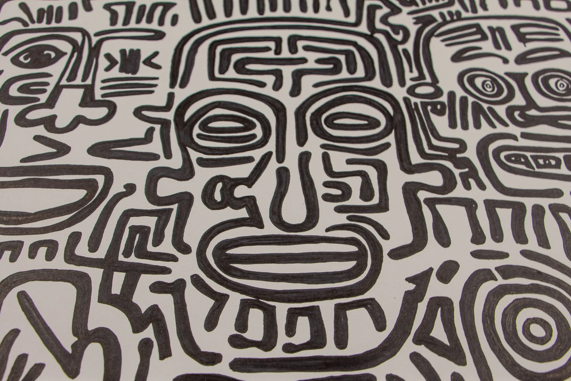 Mêlée of Discovery 004: central detail of a frontal face formed in dark hand-drawn lines, surrounded by a dense field of shifting symbols and abstract figures.