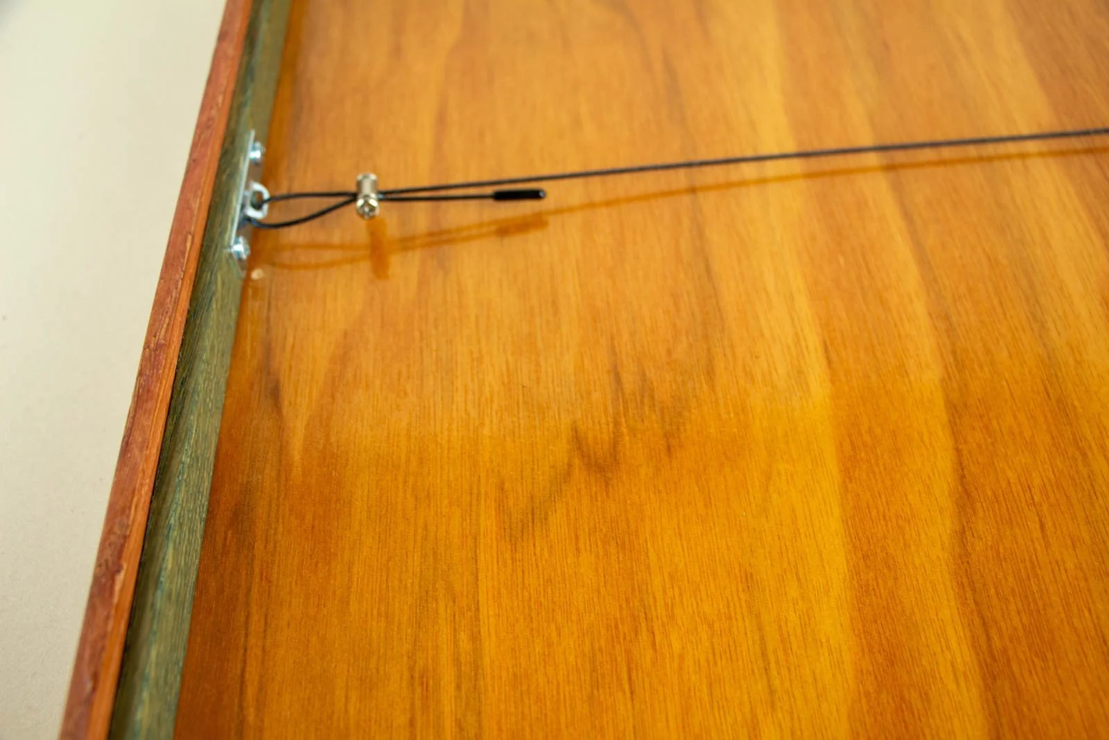 Formless Equation 003 frame back: hanging wire and clamp at left bracket, hardware mounted securely to the rail