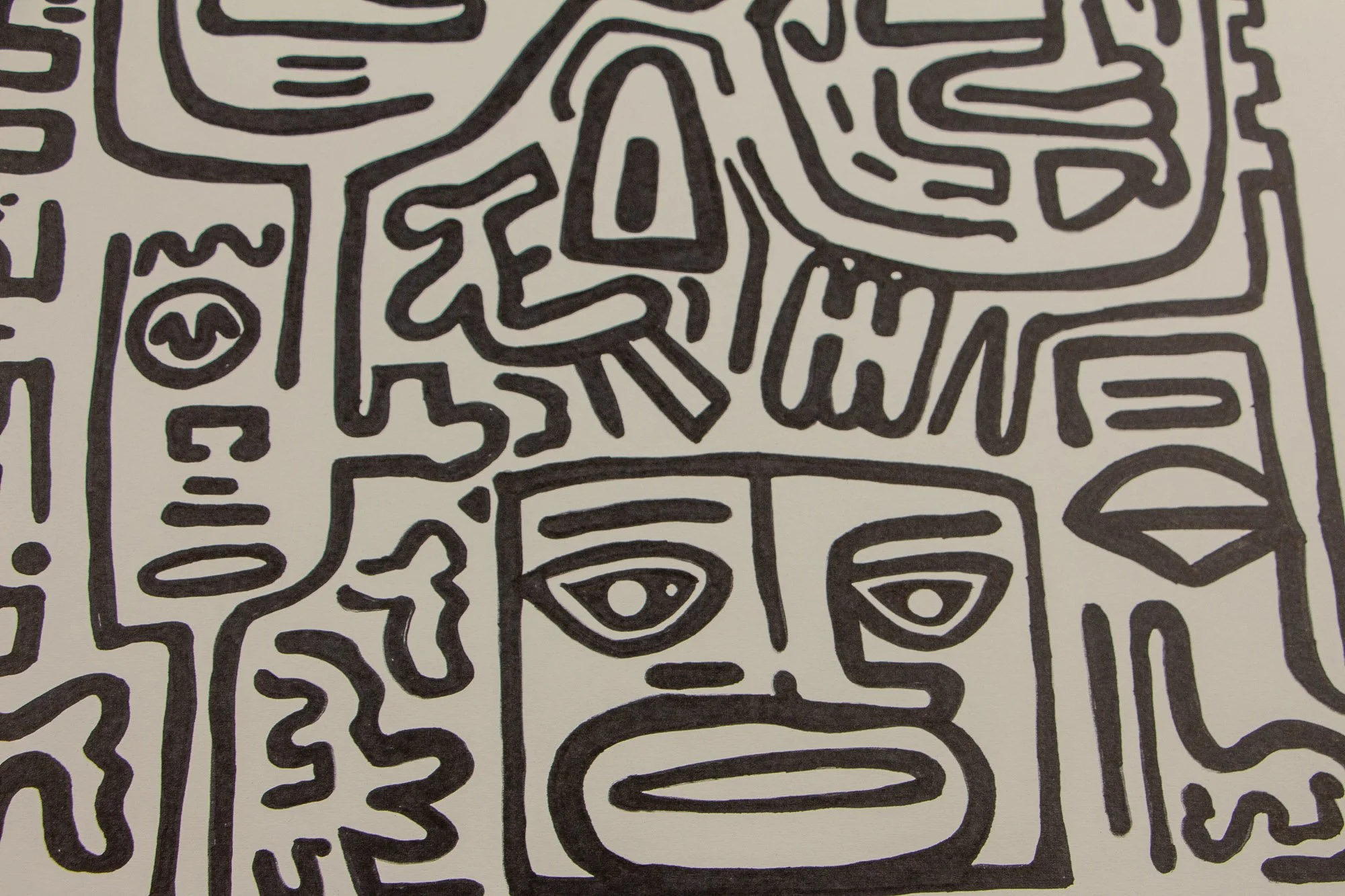 Resonant Syntax 004 detail: lower central section with a square face, almond eyes, and an elongated mouth, surrounded by clustered linear forms and adjacent abstract facial fragments in black ink