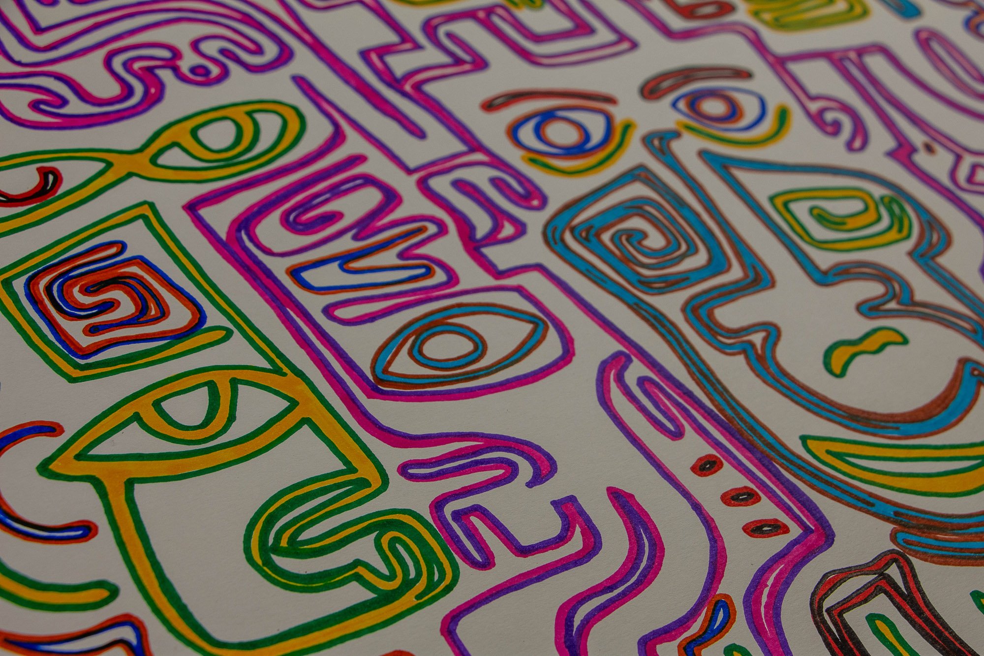 Eclipsing Gravitas 003 detail: oblique view across clustered face-like forms and symbols in pink, violet, green, blue, and red, showing the dense spatial rhythm and the repeated use of eyes, spirals, and geometric features.