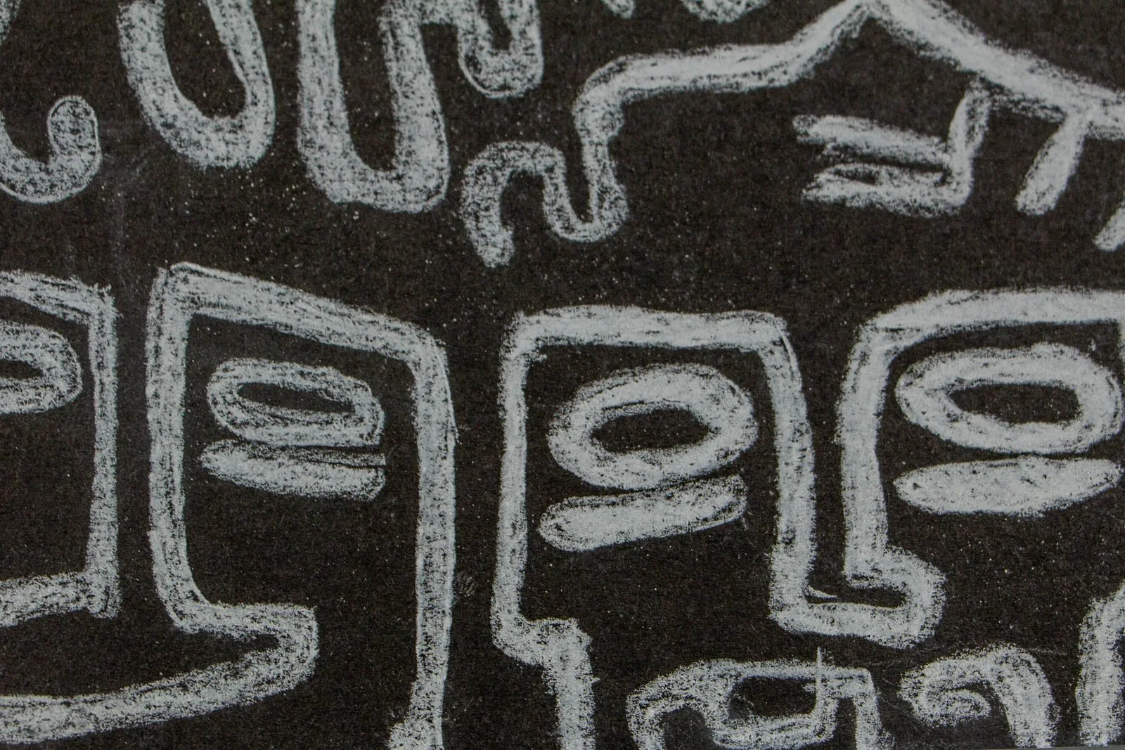 Synaptic Mythos 002 detail: trio of square faces in a row, hollow oval eyes inside rectangular heads; gritty paper grain visible