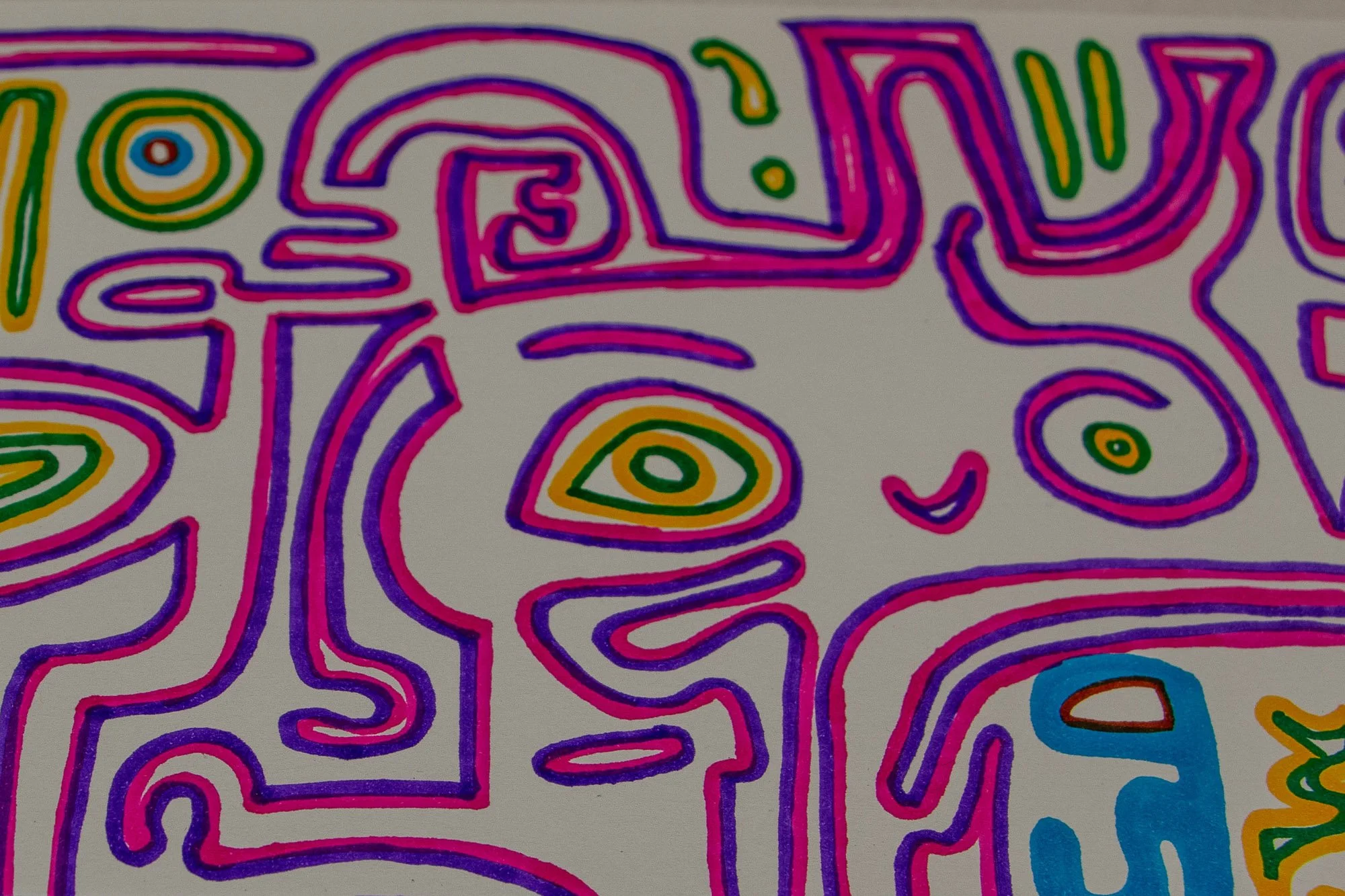Eclipsing Gravitas 003 detail: close-up of a face-like form outlined in pink and violet, with a yellow-green eye, a small curved mouth, and a blue figure-like shape at the lower edge, surrounded by circular and linear motifs on white paper.