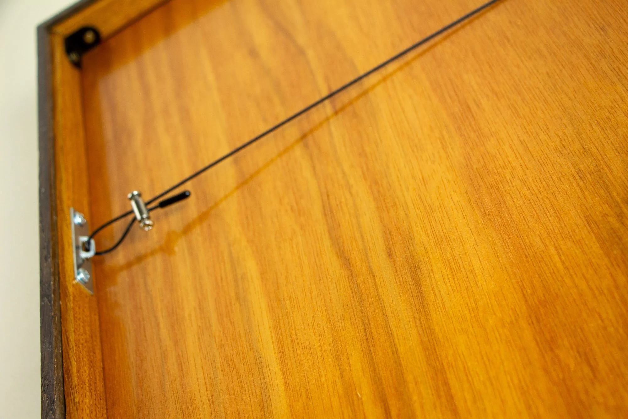 Luminous Parallax 001 frame: reverse view of the framed work, showing the meranti plywood back panel, hanging wire system, and clean, functional assembly across the rear surface.