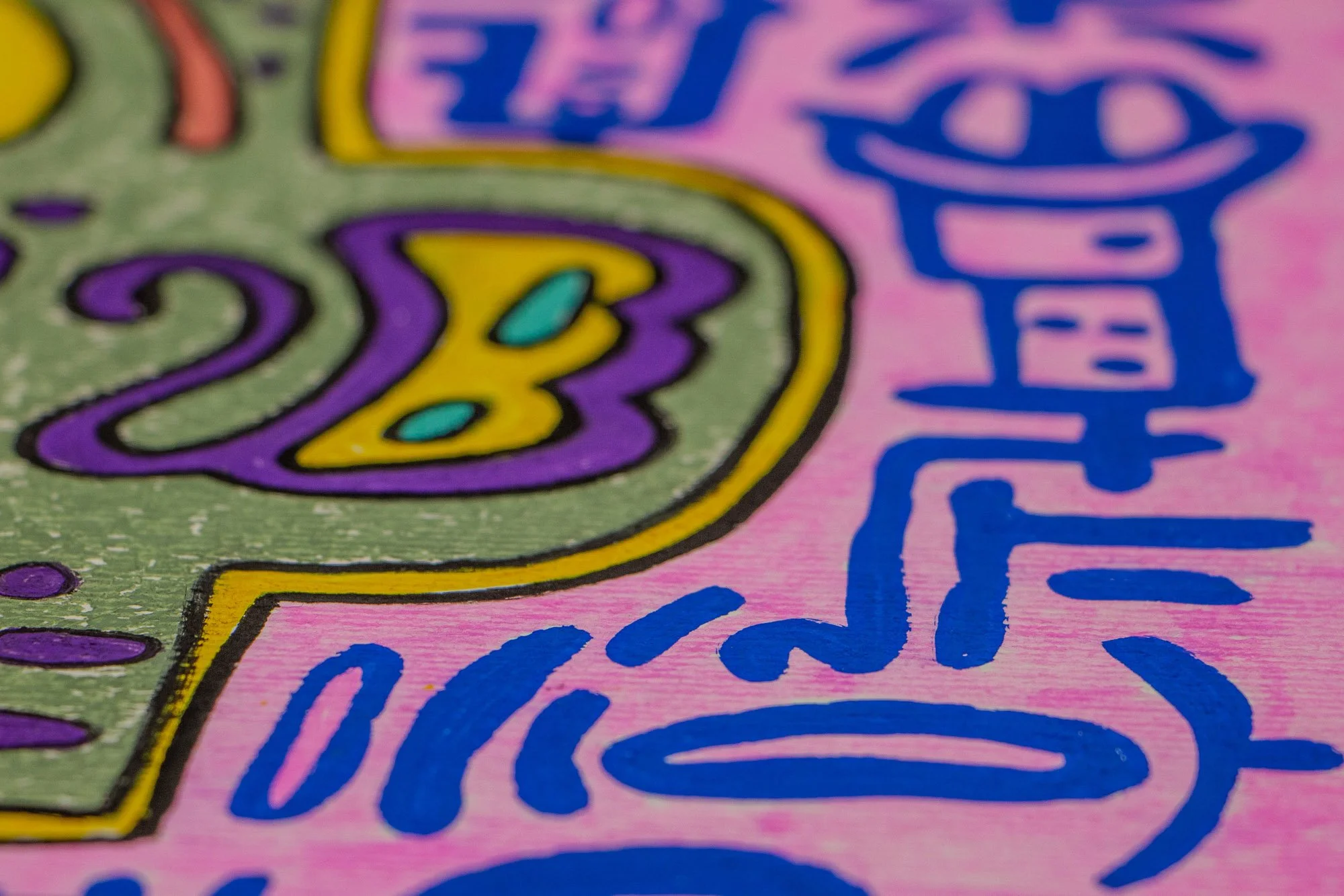 Unseen Signifiers 007 detail: soft-focus close-up of a purple-and-yellow side motif within the olive-green form, with blue symbols on the pink background receding behind it.