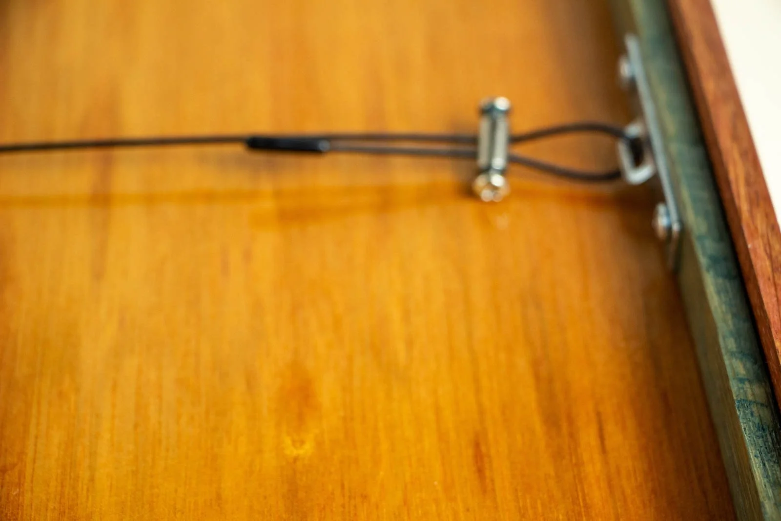 Formless Equation 003 frame back: close-up of wire and clamp at right bracket, clean installation on finished panel