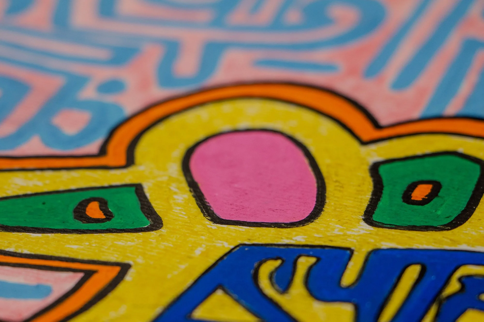 Unseen Signifiers 006 detail: close-up of the upper central head, focusing on a pink oval form set within the yellow crown-like contour above the blue symbolic patterning.