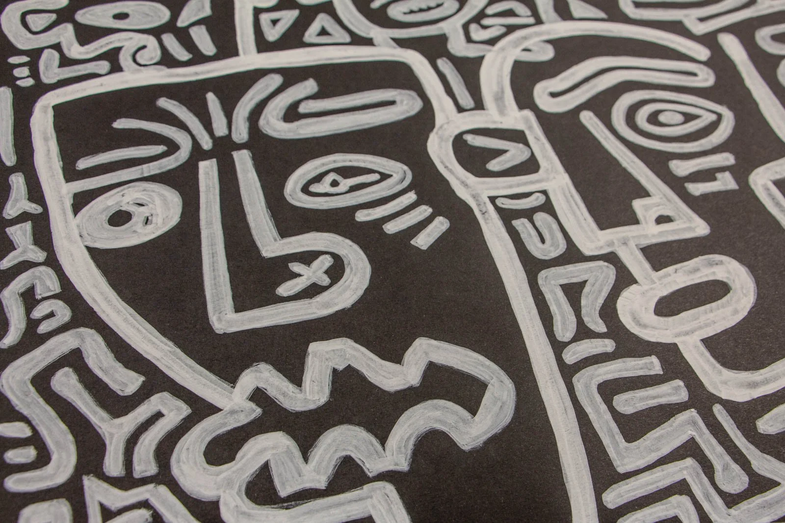 Metamorphic Entwining 002 detail: enlarged left profile with arched brow and elliptical eye, zigzag speech shape below, thick layered strokes, white ink on black paper