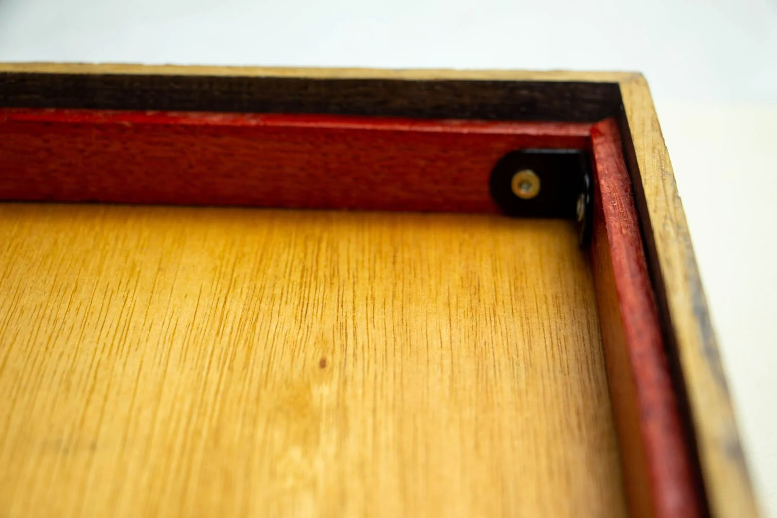 Flux Impromptu 002 frame: signature corner, white paper reveal with artist mark; red liner traces the throat against the dark oak outer