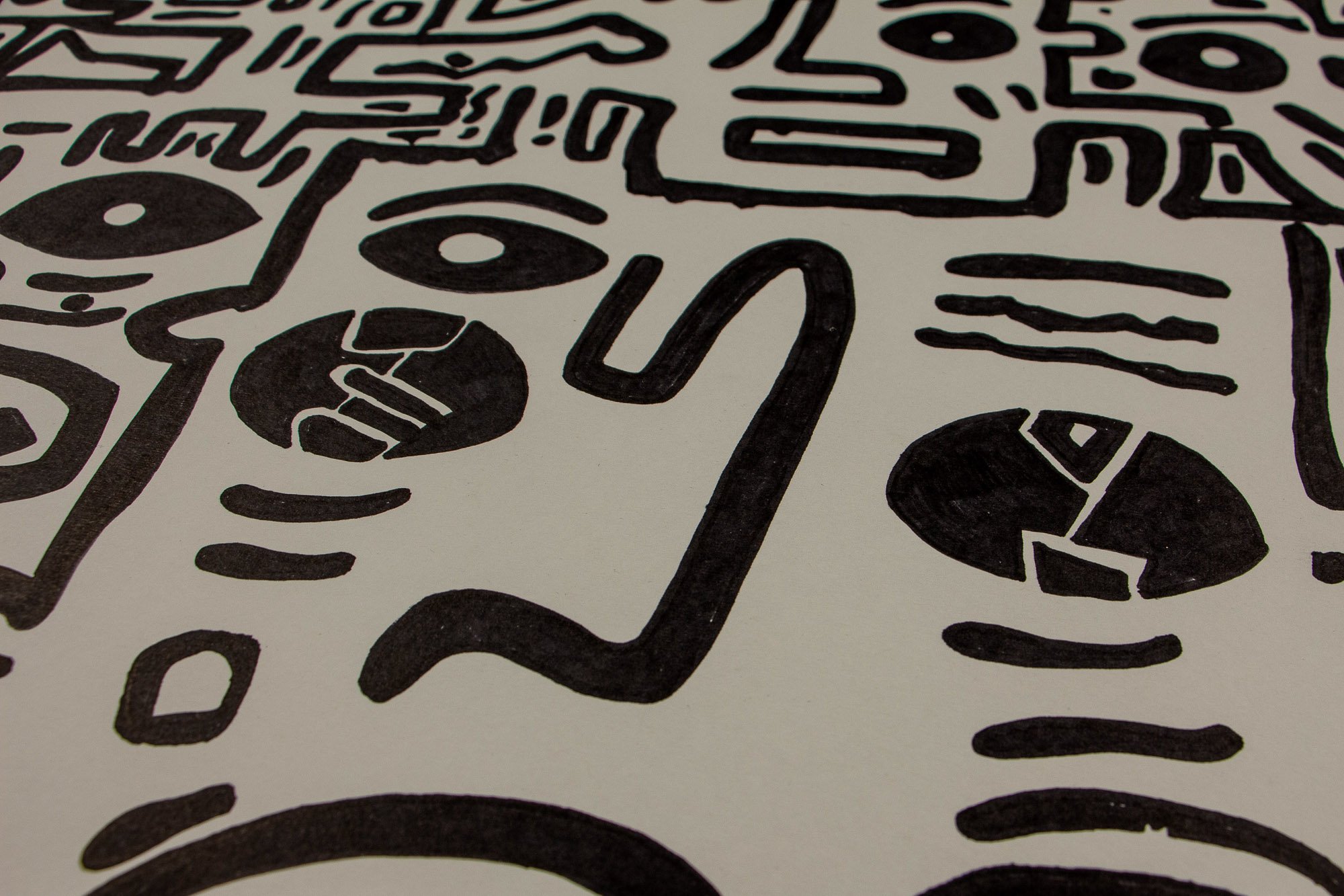 Elusive Cocoon 001 detail: close-up of a central curved vertical form between two dark symbolic oval shapes, with surrounding linear accents and bold black ink marks on warm white paper.