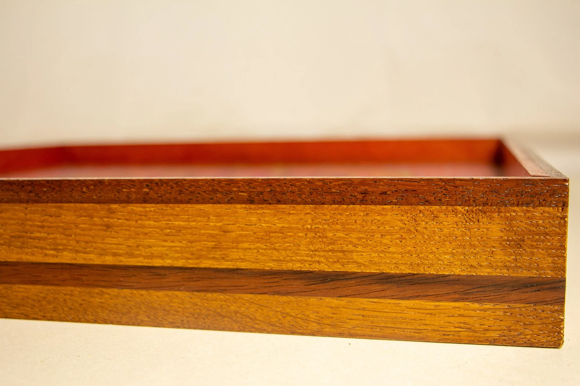 Unseen Signifiers 008 frame detail: frontal close-up of the right section of the frame, showing the warm-toned layered wood bands and the crisp upper edge beneath the glazing. mahogany, oak and beech wood.