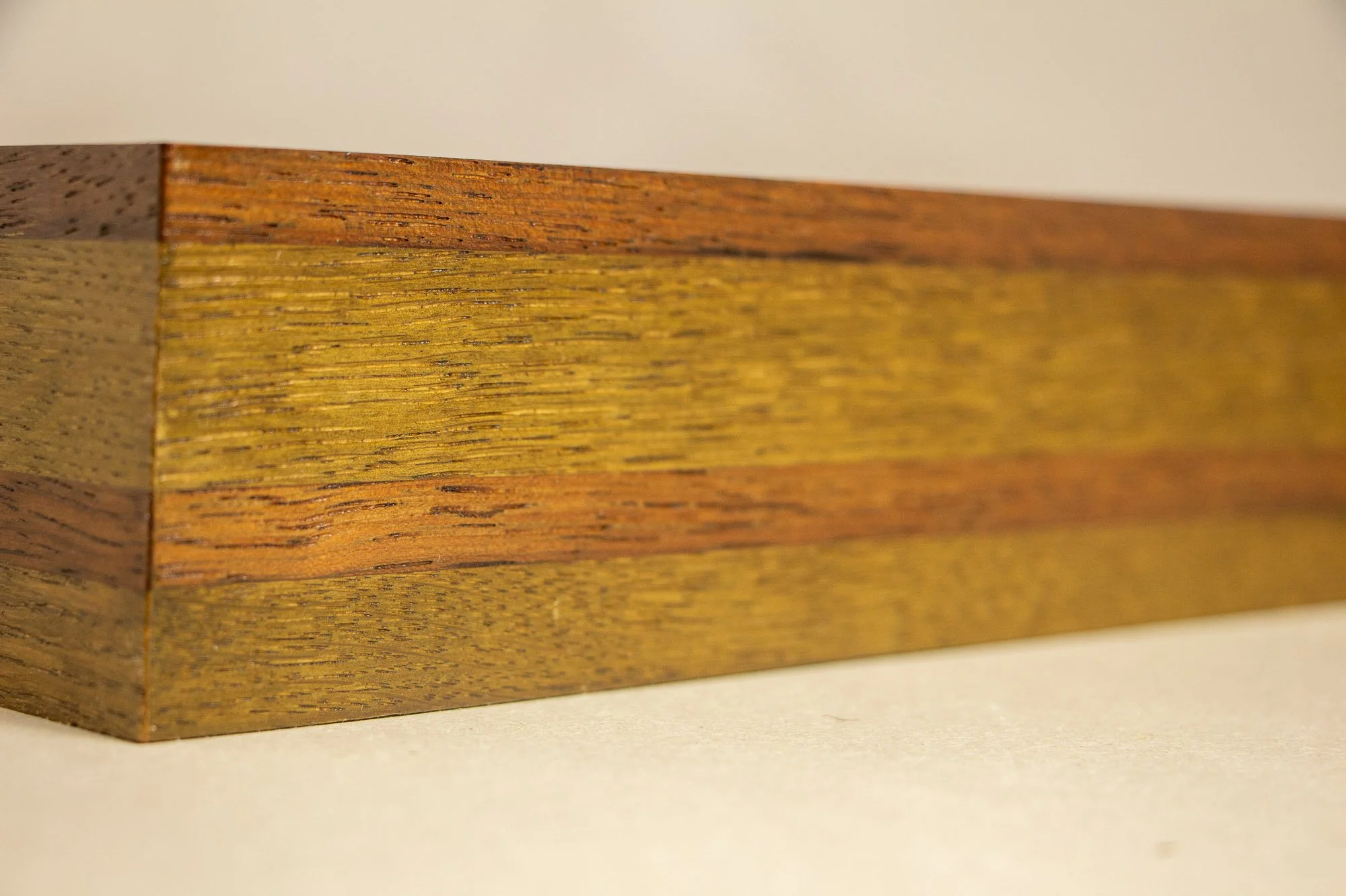 Unseen Signifiers 007 frame detail: oblique close-up of the upper inner frame, showing the olive-toned inner liner, reddish-brown outer edge, and the artwork visible behind the glass. mahogany, oak and beech wood.