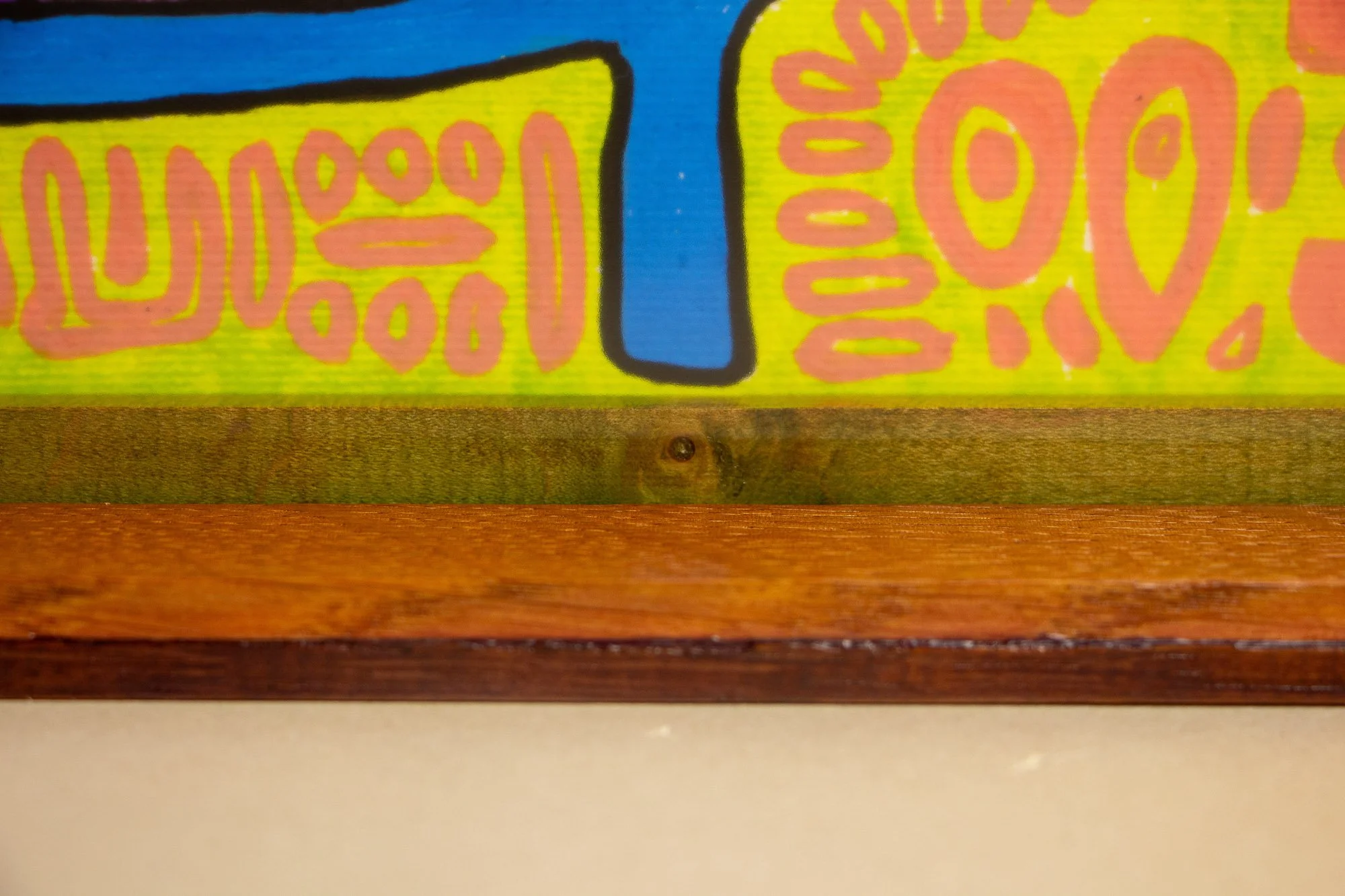 Unseen Signifiers 009 frame detail: close-up through the acrylic of the lower frame edge, showing the dark inner spacer with visible knot detail and the layered warm brown frame construction. mahogany, oak and beech wood.