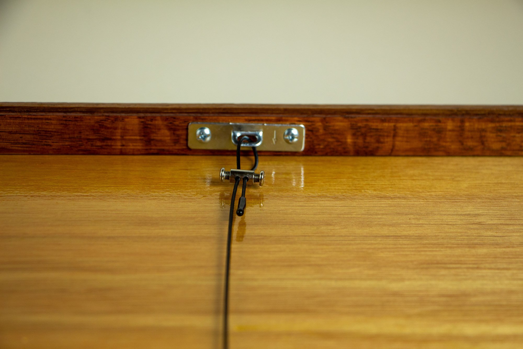 Unseen Signifiers 008 back detail: centered rear close-up of the hanging hardware, showing the metal plate, black hanging cable, and adjustable connector mounted on the back of the frame.